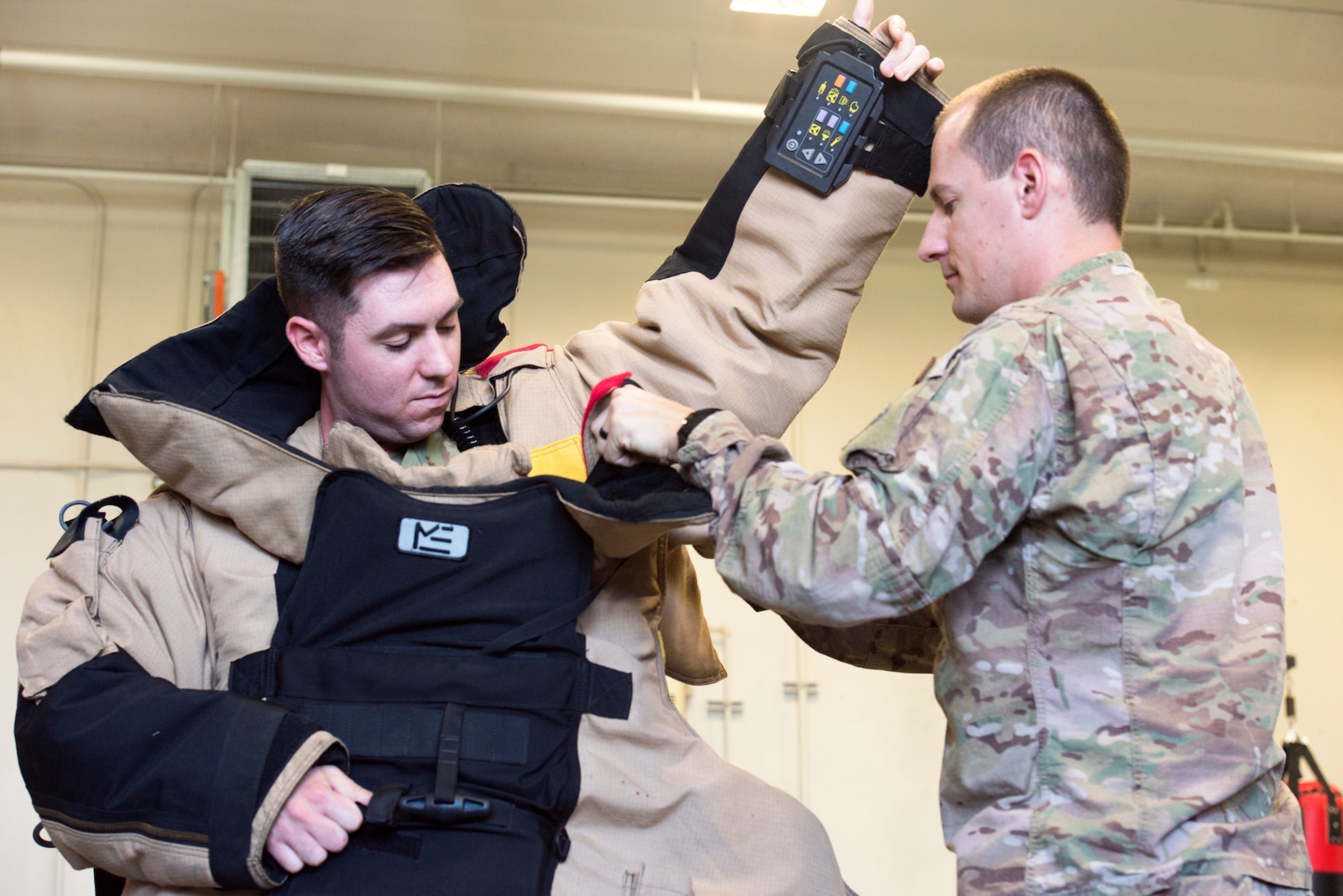 6th Civil Engineer Squadron (CES) Explosive Ordnance Disposal flight member assists Airman Leadership School (ALS) class 19-G student as he dons a bomb suit at the ALS Immersion with CES Oct. 16, 2019, MacDill Air Force Base, Fla. The 6th CES participated in the Squadron Mentorship program for ALS by demonstrating their individual units’ capability and explaining their mission to future NCO’s.