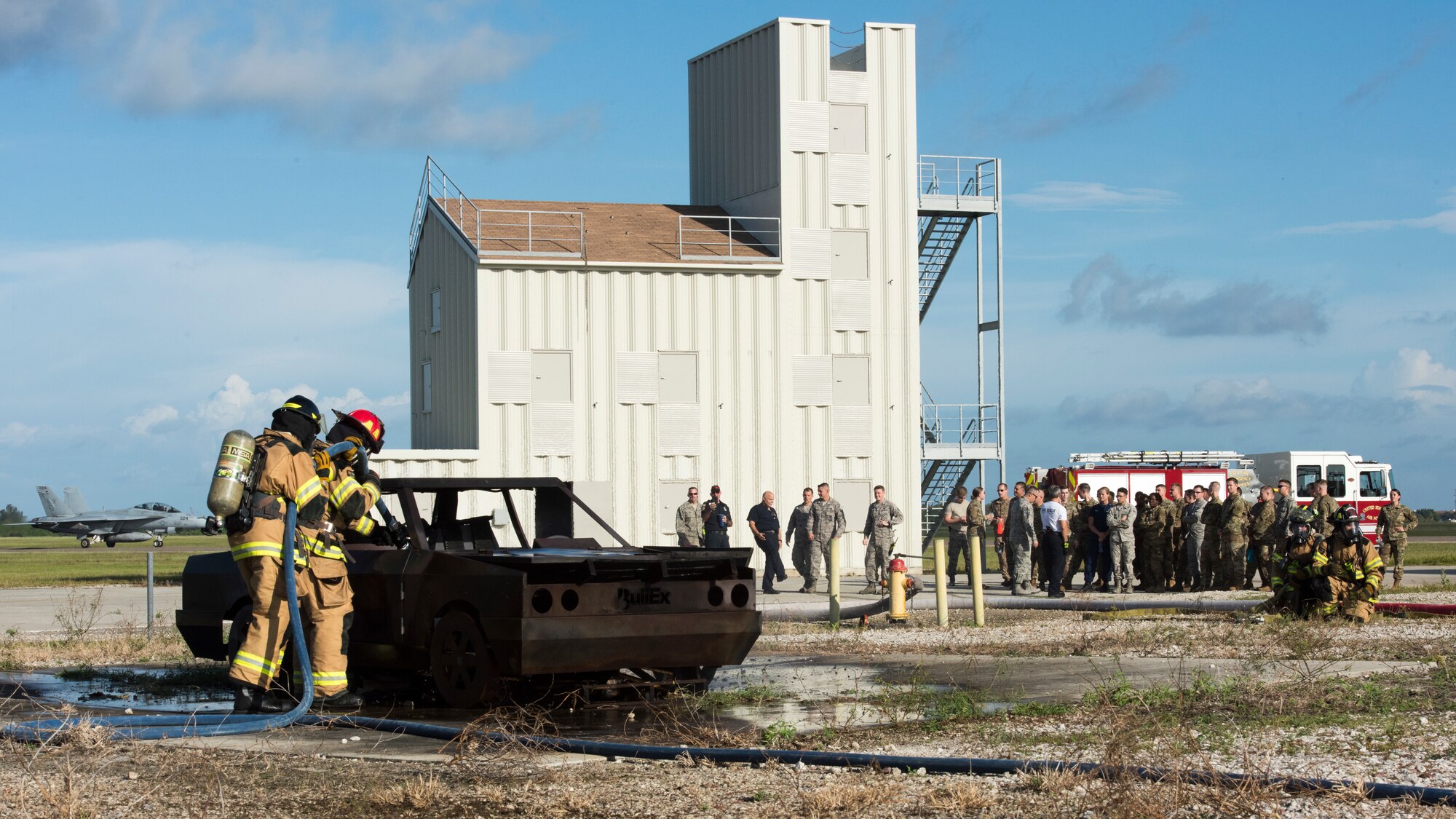 6th Civil Engineer Squadron (CES) Fire Emergency Services flight members douse an automobile fire in front of the Airman Leadership School (ALS) Class 19-G during an ALS Immersion on Oct. 16, 2019, MacDill Air Force Base, Fla. The 6th CES participated in the Squadron Mentorship program for ALS by demonstrating their individual units’ capability and explaining their mission to future NCO’s.