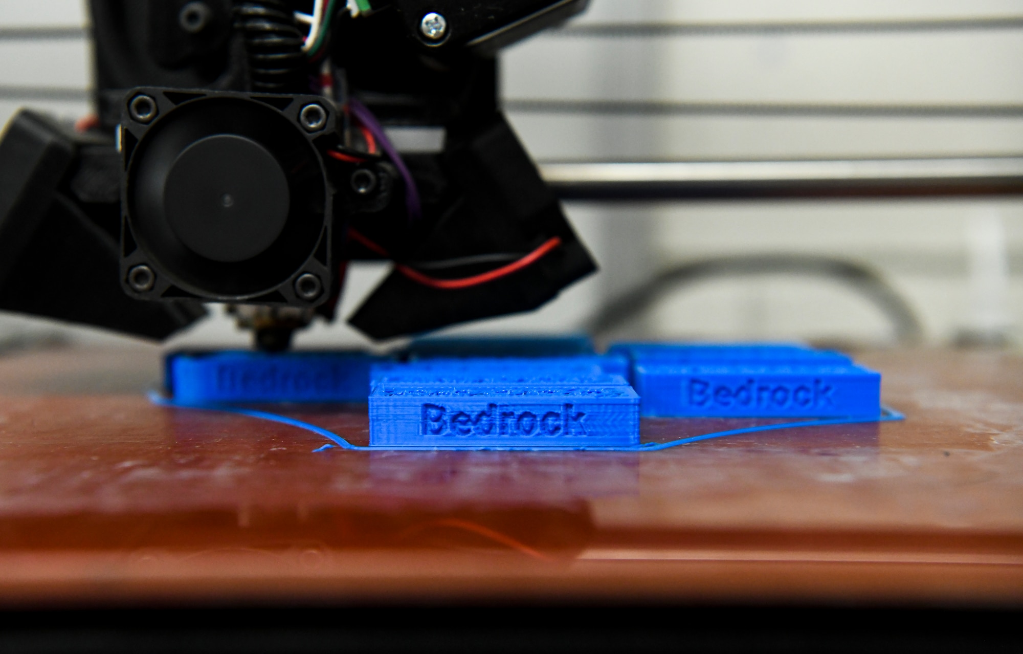 3D printing machine printing blocks with the name Bedrock on it Oct. 25, 2019 at Dover Air Force Base, Del. Bedrock provides Team Dover an opportunity to volunteer their knowledge and skills for the improvement of the base. (U.S. Air Force photo by Senior Airman Christopher Quail)