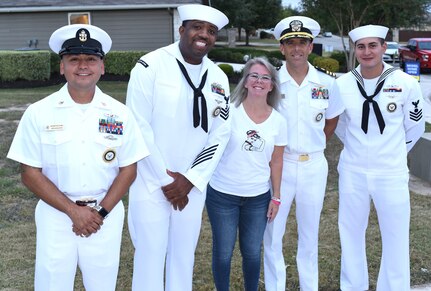 To bring some happiness to a local child, Sailors assigned to Navy Recruiting District San Antonio visited the New Braunfels home of Isaac Juarez, 7, who has been diagnosed with terminal cancer.  From left are Senior Chief Petty Officer Israel Flores, Petty Officer 1st Class Harold Dayse, Jacki Jacob of New Braunfels, Texas; Cmdr. Nicholas Gamiz and Petty Officer 1st Class Chance Tahah. The Sailors presented Isaac with an Honorary Sailor Certificate, an America’s Navy ball cap, a Forged by The Sea T-shirt, a Navy Fiesta Medal, and a copy of the U.S. Constitution.