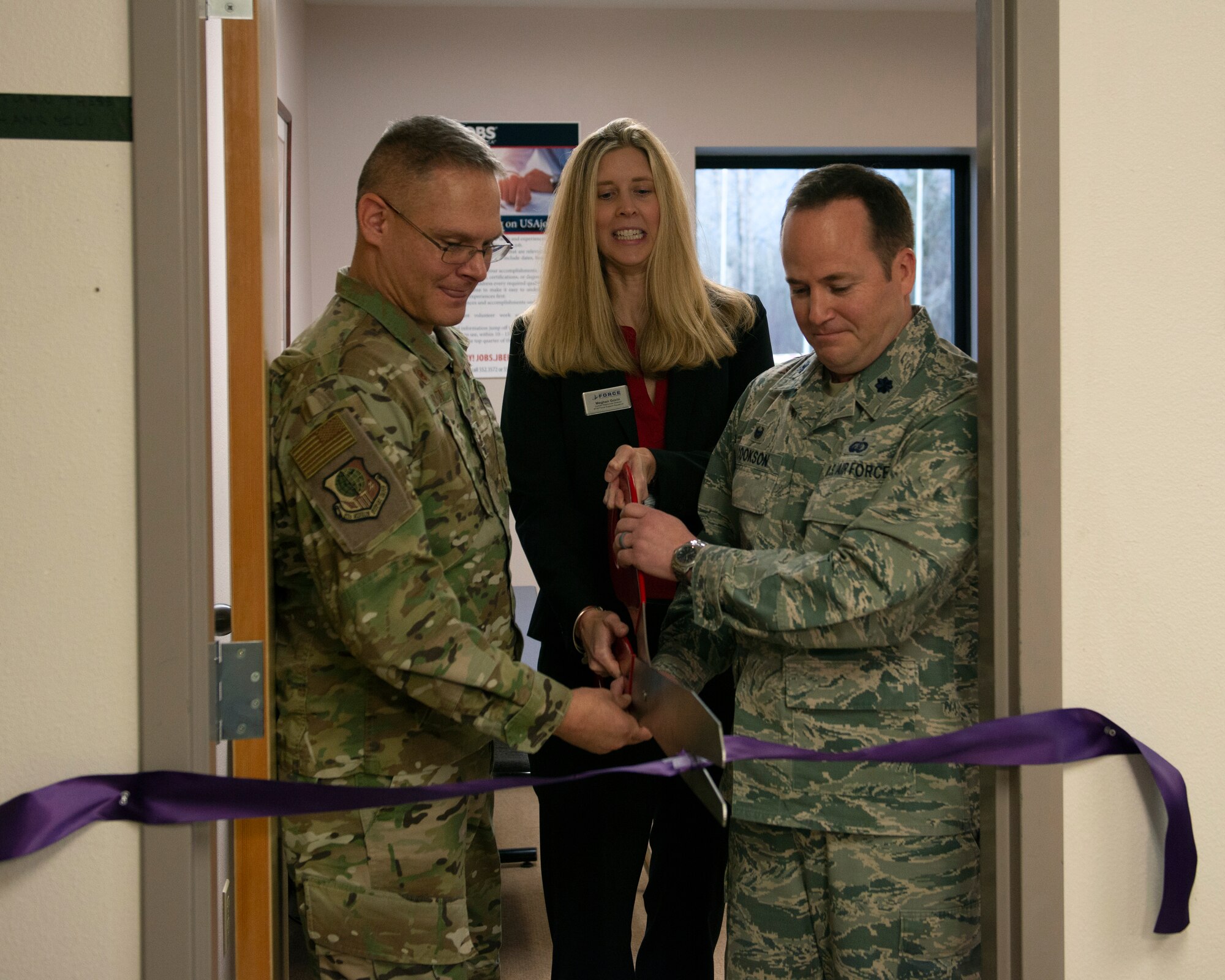 From left, U.S. Air Force Col. John Caranta III, the 673d Mission Support Group commander, Meghan Goven, Non-Appropriated Fund Human Resources director, and U.S. Air Force Lt. Col. Diamond Cookson, the 673d Force Support Squadron commander, cut a ribbon during a ceremony for a new Non-Appropriated Fund Human Resources Applicant Assistance Office at Joint Base Elmendorf-Richardson, Alaska, Oct. 28, 2019. The new office will provide assistance navigating the Non-Appropriated Fund employment application process to applicants without base access.