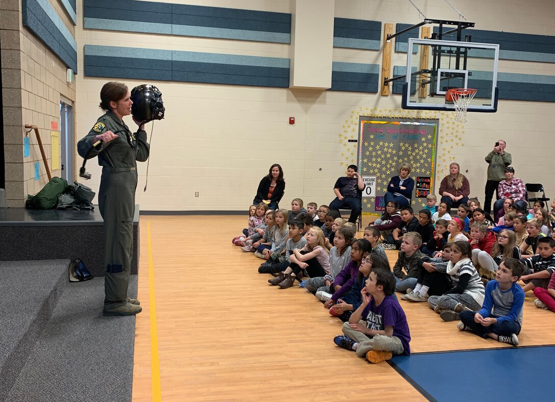 Col. Gina Sabric, 419th Fighter Wing commander, speaks to students about the F-35 Lightning II helmet worn during flight.