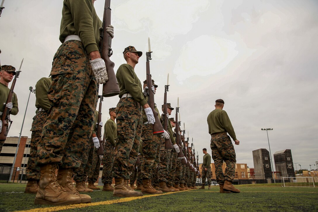 Marines with Alpha Company, Marine Barracks Washington, practice “present arms” at Marine Barracks Washington, D.C., Oct. 29, 2019. The Marines hone their rifle drill during Ceremonial Drill School. (U.S. Marine Corps photo by Lance Cpl. Allen Sanders)