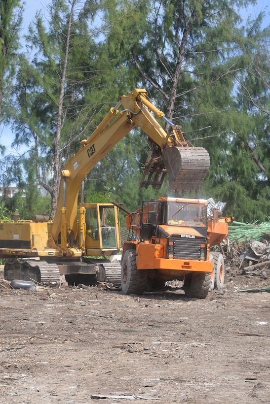 Heavy equipment loads a truck with scrap material