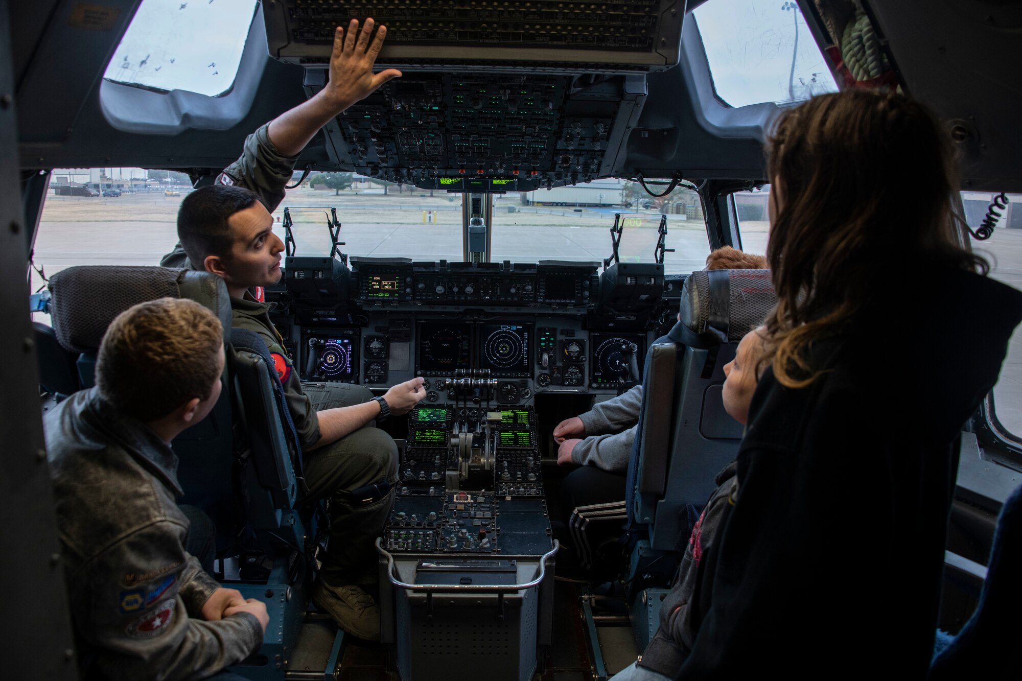 U.S. Air Force Capt. Dan Godshalk, a pilot assigned to the 58th Airlift Squadron, shows the controls of a C-17 Globemaster III to students of the STARBASE program