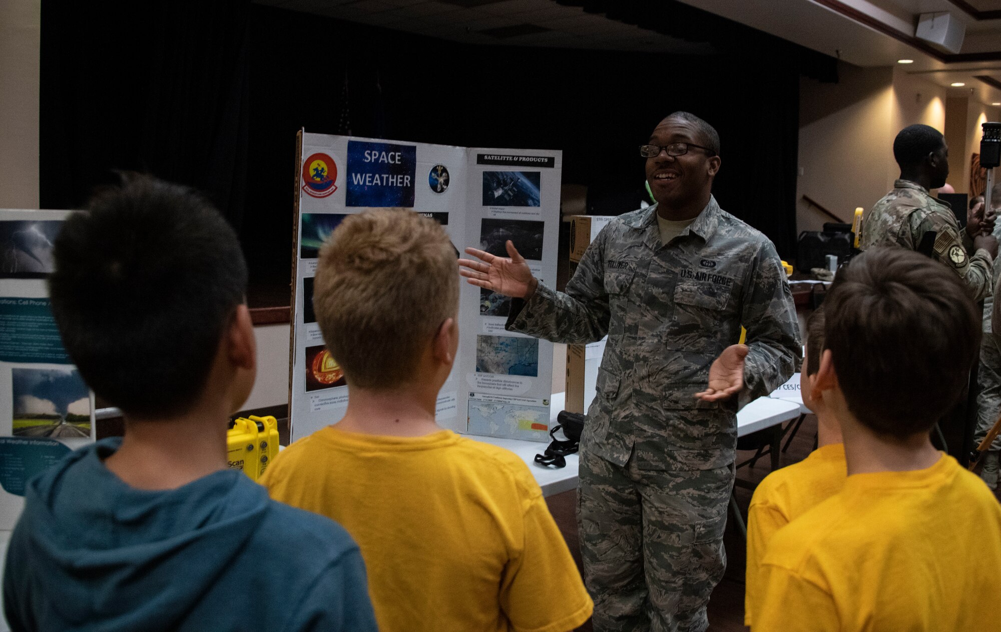 U.S. Air Force Airman 1st Class Julius Tolliver, a weather forecaster assigned to the 97th Operations Support Squadron, explains how forecasting weather aids in operations on base to students of the STARBASE program