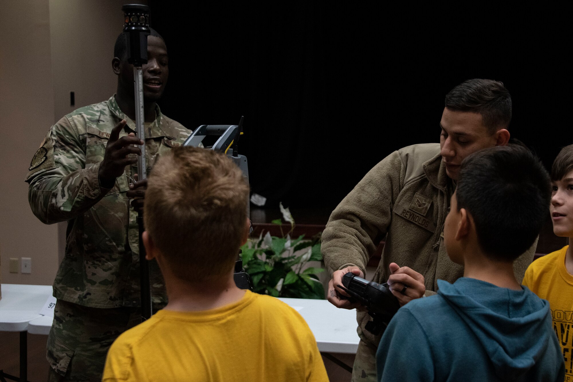 U.S. Air Force Senior Airman Gregory Reynolds, an engineering journeyman assigned to the 97th Civil Engineer Squadron, showcases the robotics total station to students of the STARBASE program