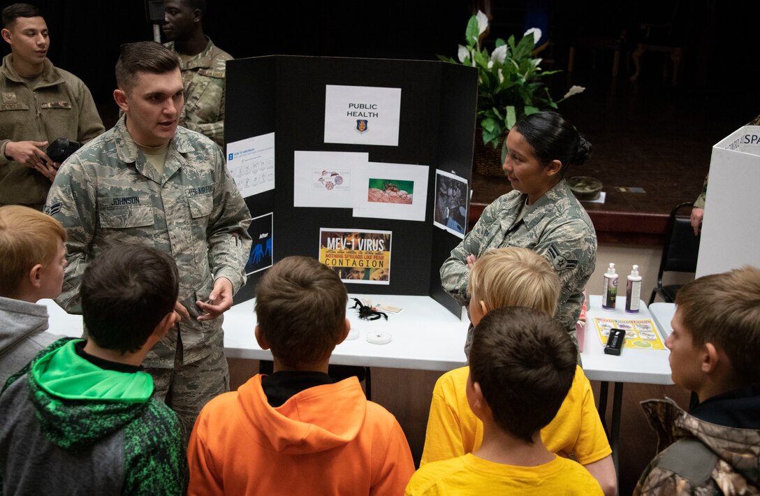 U.S. Air Force Airman 1st Class Levi Johnson, a public health technician assigned to 97th Operational Medical Readiness Squadron, discuss how public health helps the base with students of the STARBASE program