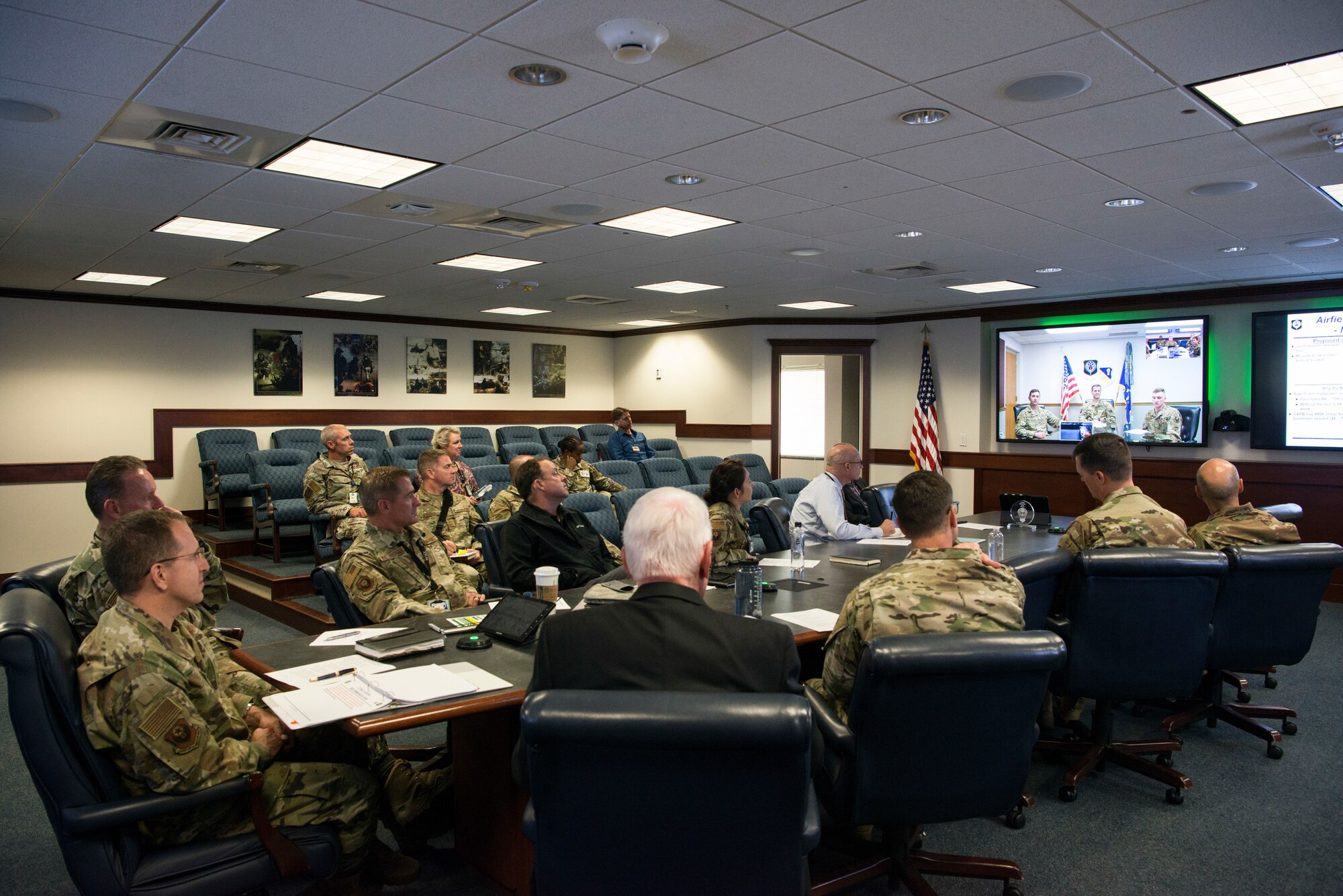 A group of people observing a presentation in a room.