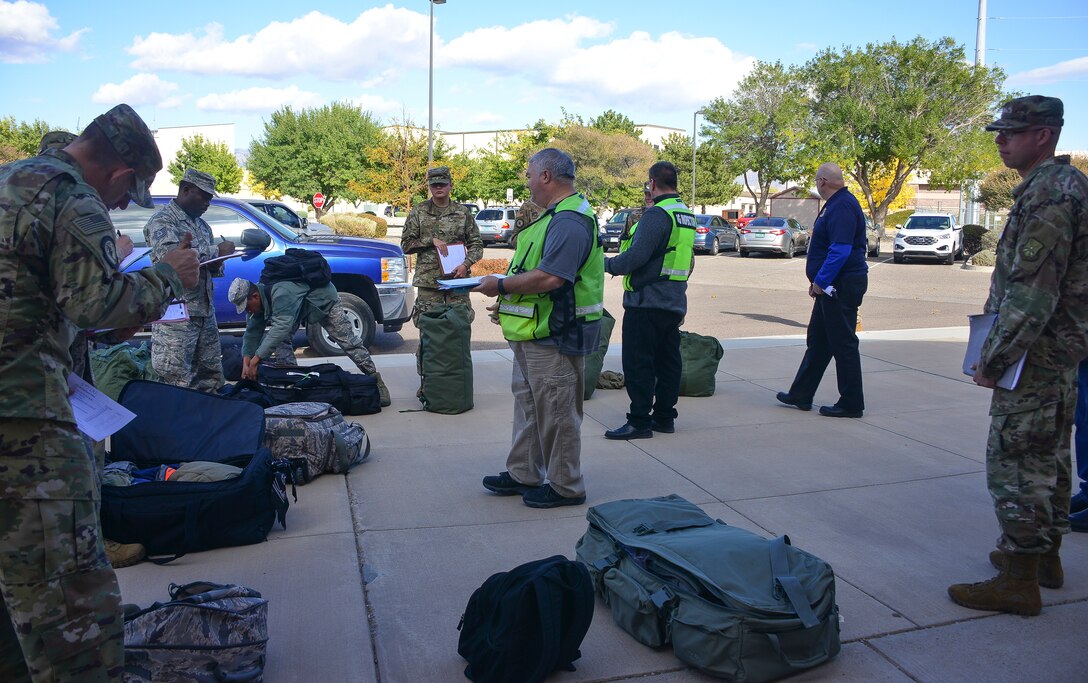 Members of the U.S. Air Force Inspector General’s Office inspect baggage during a mass deployment as part of exercise Global Thunder 20 at Kirtland Air Force Base, N.M., Oct. 24, 2019. Large-scale exercises, like Global Thunder, involve extensive planning and coordination to provide unique training for assigned units and allies. (U.S. Air Force photo by Staff Sgt. Kimberly Nagle)