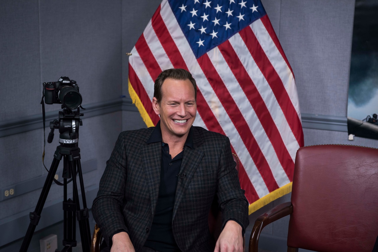 A man sits in a chair.