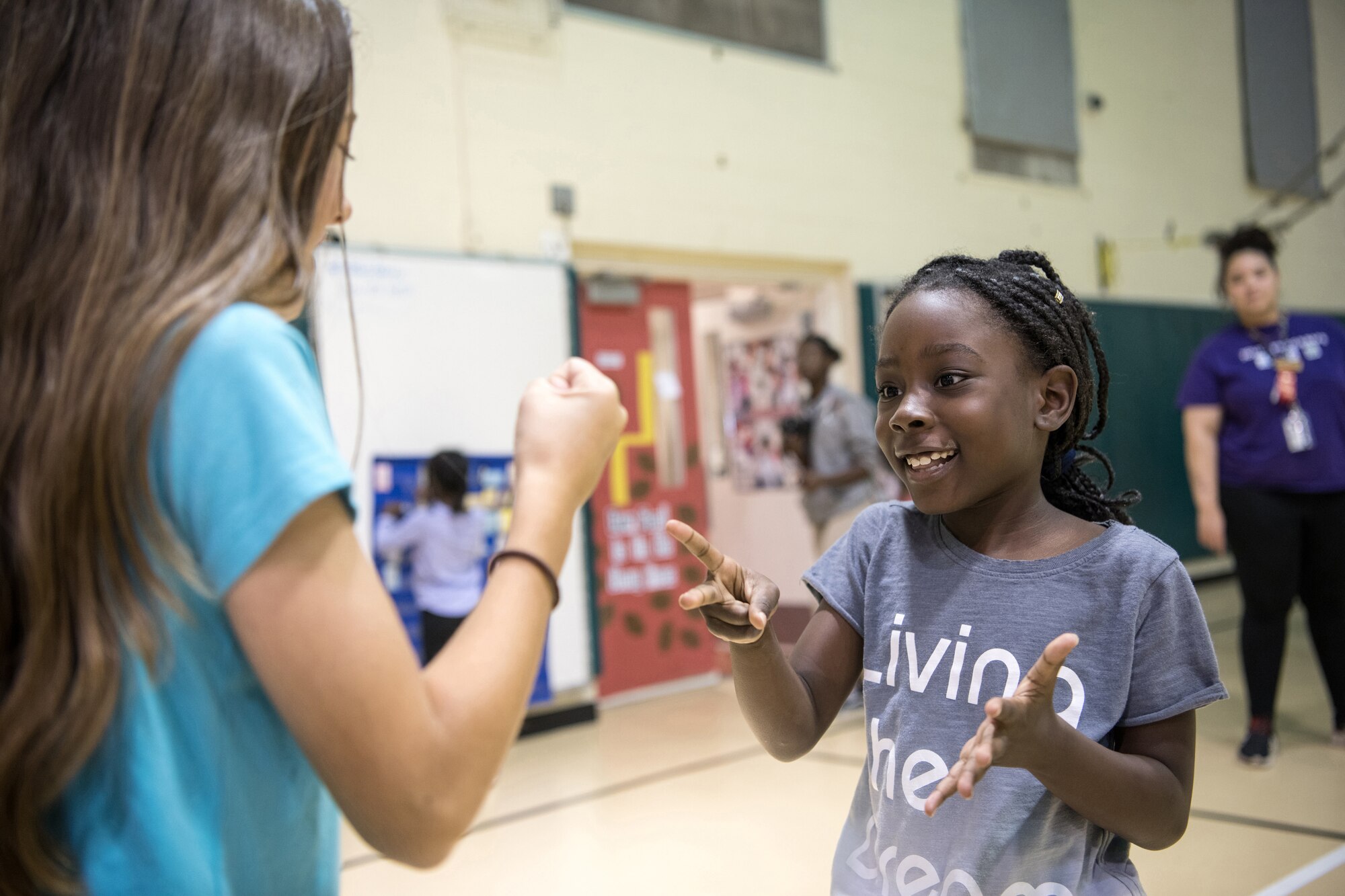 Amira Wilder, 8, throws scissors as Amaris Marquez, 11, throws rock during a rock-paper-scissors game at the Youth Center during Red Ribbon Week Oct. 23, 2019, at Travis Air Force Base, California. Red Ribbon Week is a drug prevention, awareness and educational program in conjunction with the Drug Demand Reduction Program within the Department of Defense. (U.S. Air Force Photo by Nicholas Pilch)