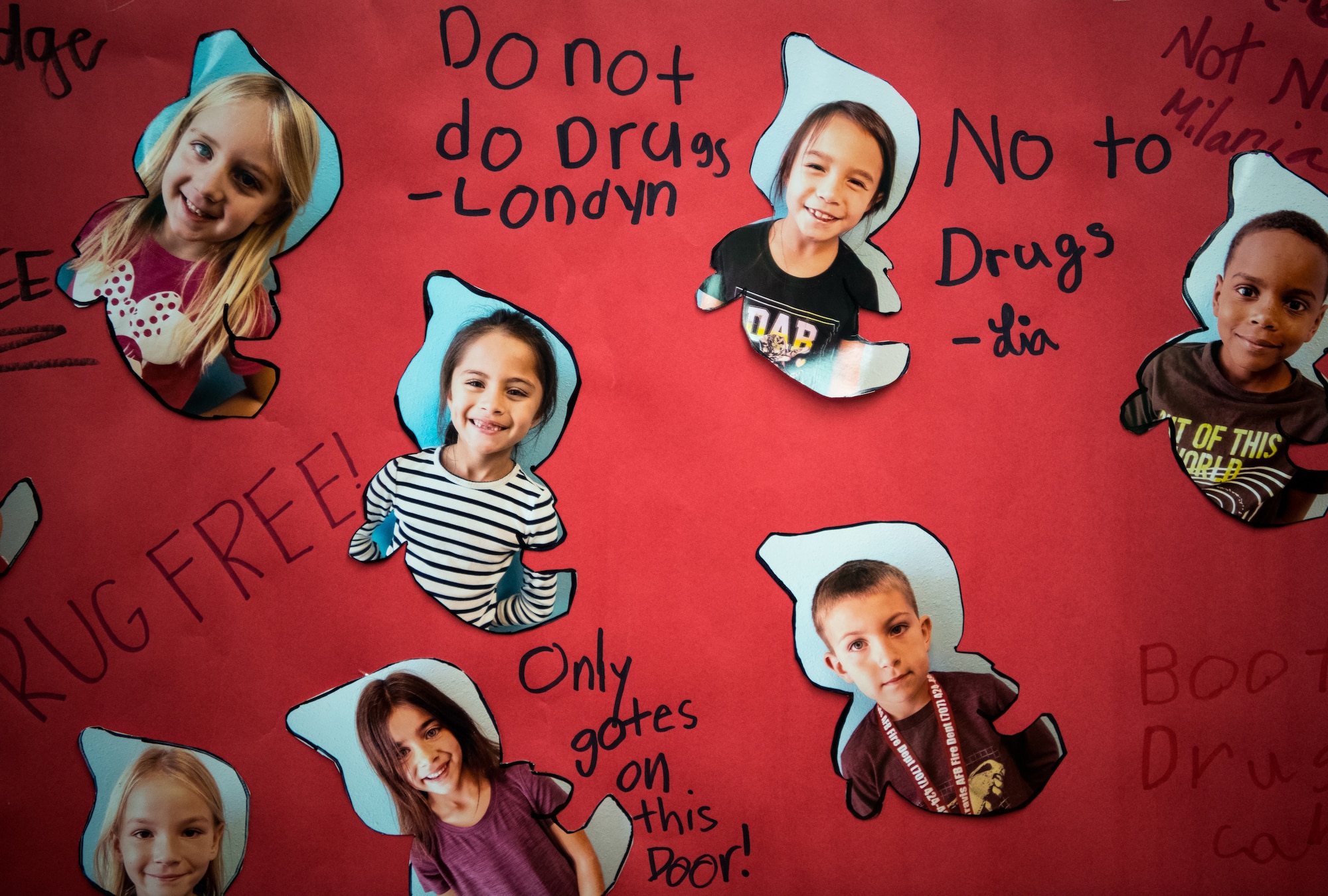 Images of children that attend the Youth Center make statements next to their picture on a red door during Red Ribbon Week Oct. 23, 2019, at Travis Air Force Base, California. Red Ribbon Week is a drug prevention, awareness and educational program in conjunction with the Drug Demand Reduction Program within the Department of Defense. (U.S. Air Force Photo by Nicholas Pilch)