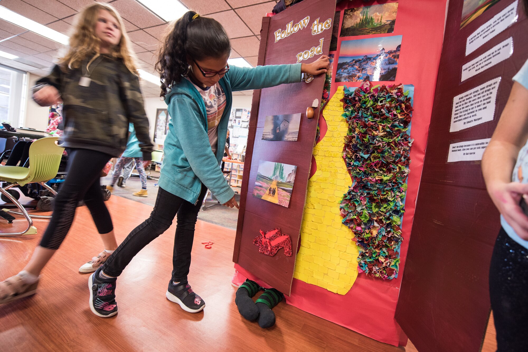 Ava Perez, 11, shows off the door for her pre-teen class at the Youth Center for Red Ribbon Week Oct. 23, 2019, at Travis Air Force Base, California. The Youth Center held a contest where students and staff decorated doors with various themes on how to be aware of the effects of drugs. Red Ribbon Week is a drug prevention, awareness and educational program in conjunction with the Drug Demand Reduction Program within the Department of Defense. (U.S. Air Force Photo by Nicholas Pilch)