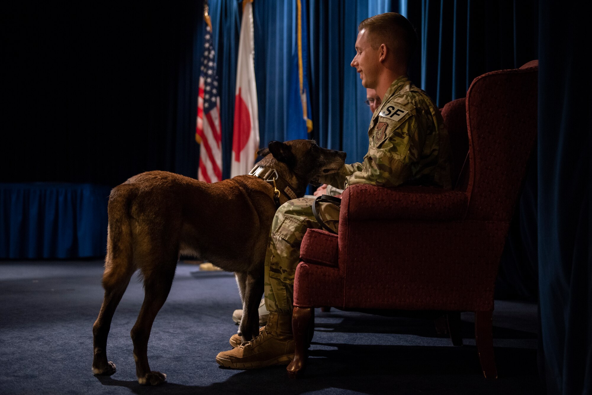 Staff Sgt. Cody Nickell, 374th Security Forces Squadron military working dog handler, shares a moment with his teammate Topa, prior to the commencement of Topa’s retirement ceremony at Yokota Air Base, Japan, Oct. 17, 2019.