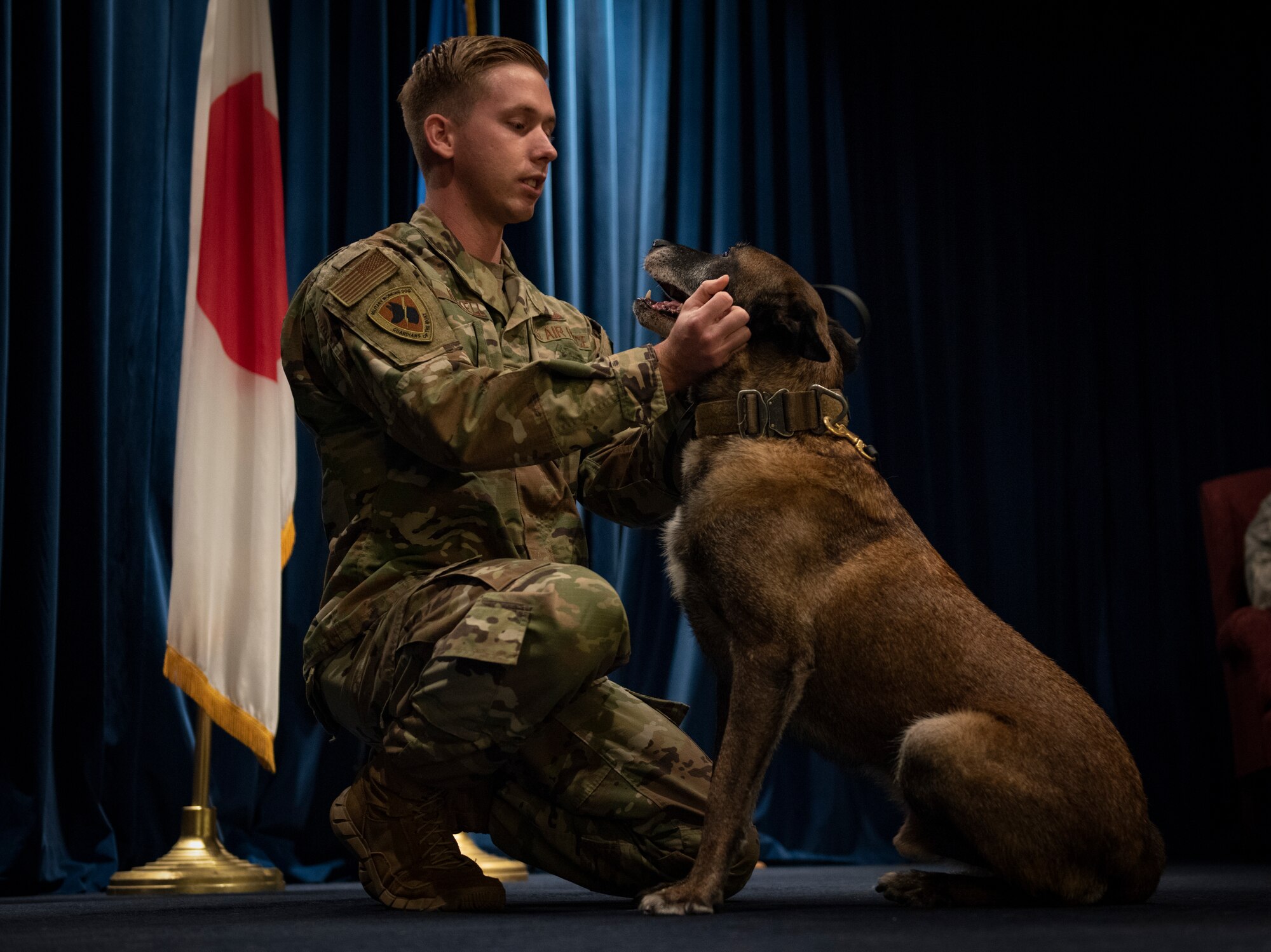 Staff Sgt. Cody Nickell, 374th Security Forces Squadron military working dog handler, shares a moment with his teammate Topa during Topa’s retirement ceremony at Yokota Air Base, Japan, Oct. 17, 2019.