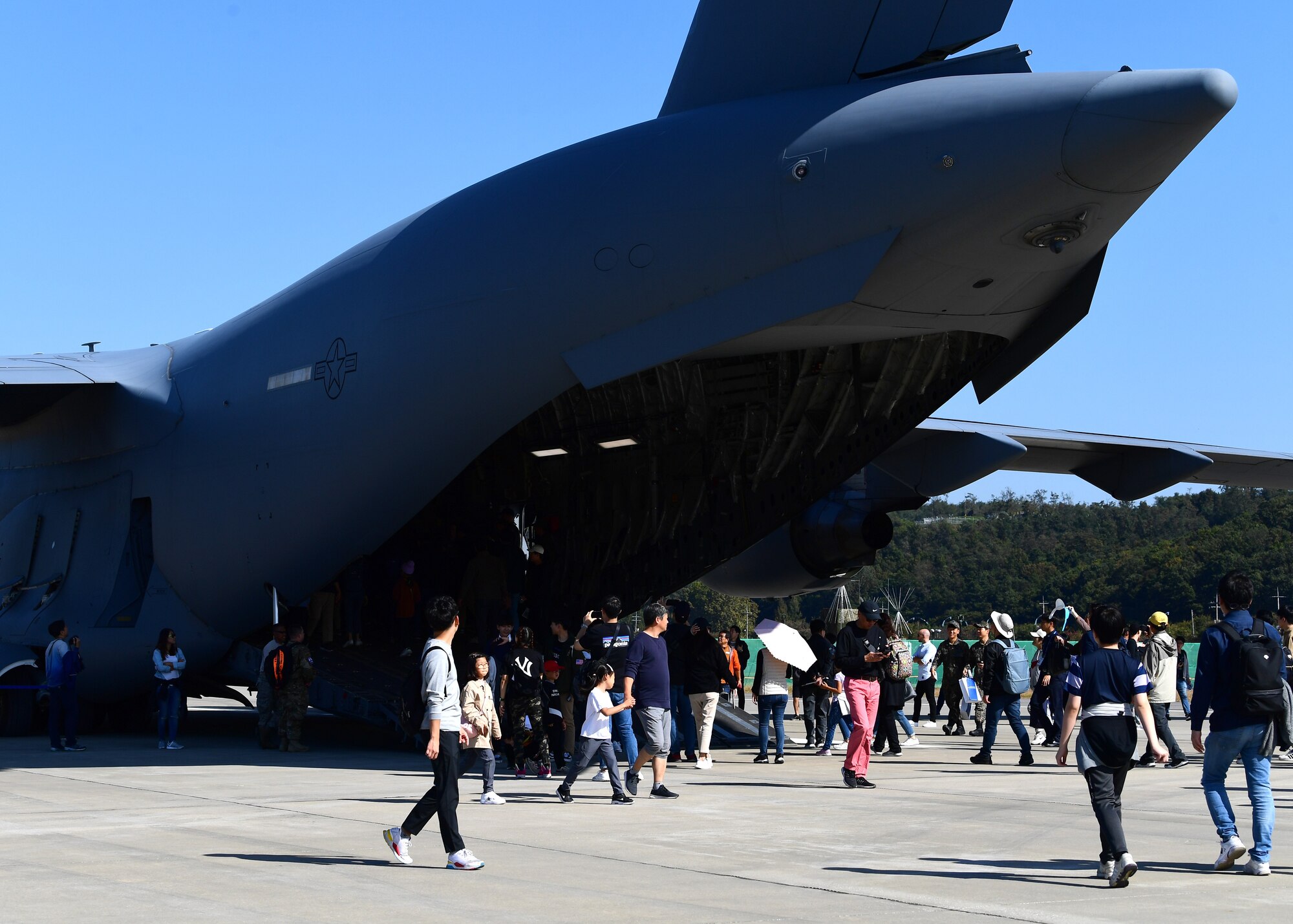 Attendees of the Seoul International Aerospace and Defense Exhibition 2019 walk around a C-17 Globemaster III assigned to the Pacific Air Forces C-17 Demonstration Team at Joint Base Pearl Harbor-Hickam, Hawaii, performs during the Seoul International Aerospace and Defense Exhibition 2019 at the Seoul Airport, Republic of Korea, October 19, 2019.