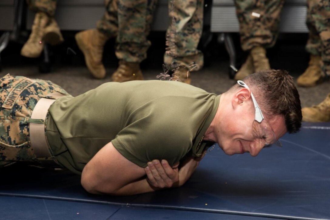 U.S. Marine Corps Lance Cpl. Antonio Castellanos, a patrol supervisor with Provost Marshal’s Office, Headquarters and Support Battalion, Marine Corps Installations Pacific, endures an electric shock during Human Electro-muscular Incapacitation Taser training at Camp Foster, Okinawa, Japan, Oct. 22, 2019.