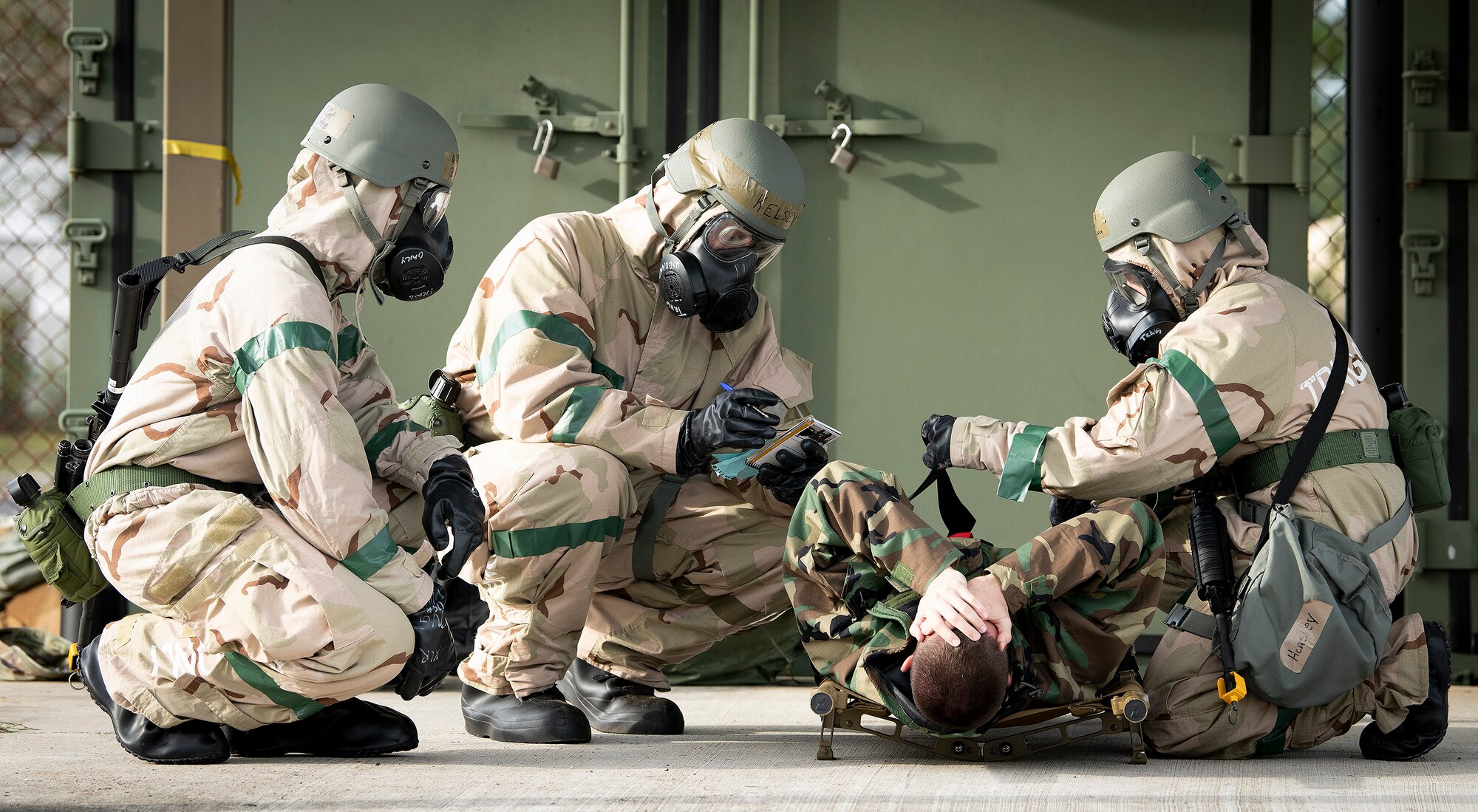 Airmen evaluate a wounded victim during a chemical, biological, radiological, nuclear and explosive exercise at Eglin Air Force Base, Florida, Oct. 24, 2019. The exercise evaluated the Airmen’s ability to meet wartime and contingency taskings of employing and sustaining the force, and the ability to survive and operate. (U.S. Air Force photo by Samuel King Jr.)