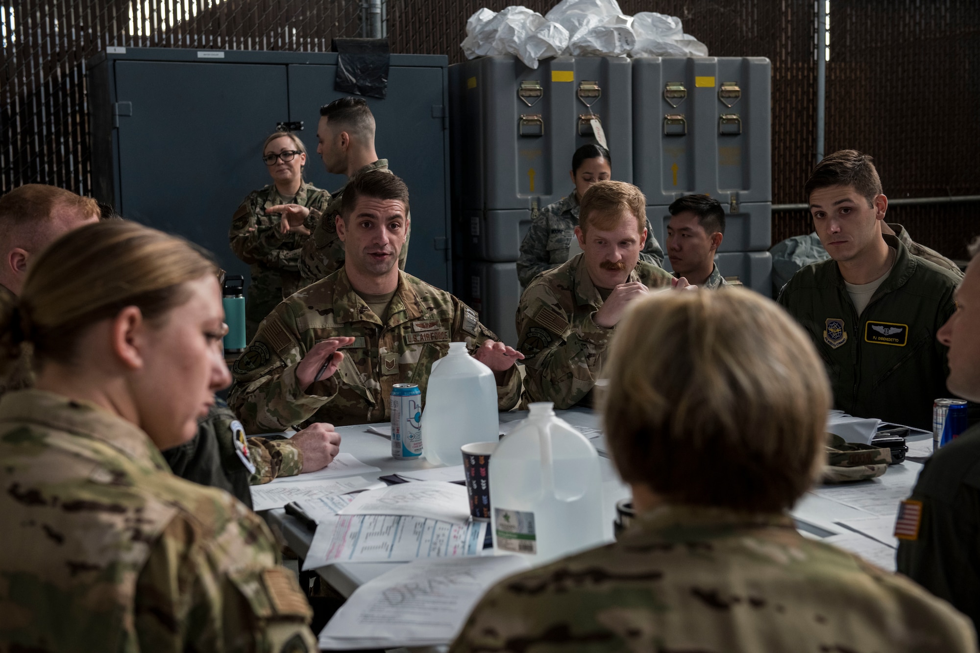 Tech. Sgt. Todd Olsson, an aeromedical technician assigned to the 43rd Aeromedical Evacuation Squadron from Pope Army Air Field, N.C., gives a mission brief to other members of the 43rd AES during a Transport Isolation System training exercise at Joint Base Charleston, S.C., October 23, 2019. The TIS is a device used to transport Ebola patients, either by C-17 Globemaster III or C-130 Hercules, while preventing the spread of disease to medical personnel and aircrews until the patient can get to one of three designated hospitals in the United States that can treat Ebola patients. JB Charleston is currently the only military installation with a TIS. The TIS mission is a sub-specialty of the aeromedical evacuation mission which requires frequent training to maintain readiness.
