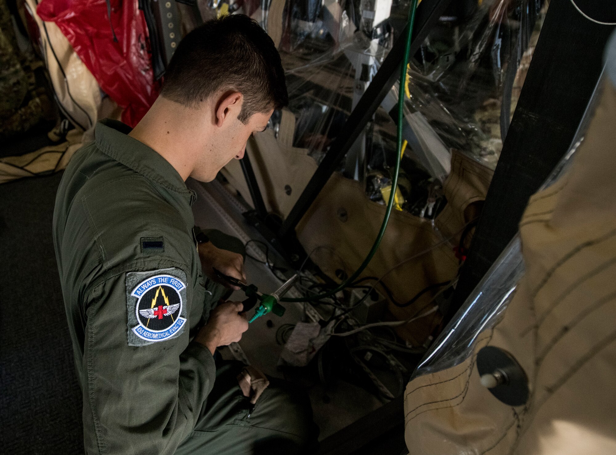 1st. Lt. PJ Didenedetto, a flight nurse assigned to the 43rd Aeromedical Evacuation Squadron from Pope Army Air Field, N.C., fastens tubing on a Transport Isolation System during a TIS training exercise at Joint Base Charleston, S.C., October 23, 2019. The TIS is a device used to transport Ebola patients, either by C-17 Globemaster III or C-130 Hercules, while preventing the spread of disease to medical personnel and aircrews until the patient can get to one of three designated hospitals in the United States that can treat Ebola patients. JB Charleston is currently the only military installation with a TIS. The TIS mission is a sub-specialty of the aeromedical evacuation mission which requires frequent training to maintain readiness.