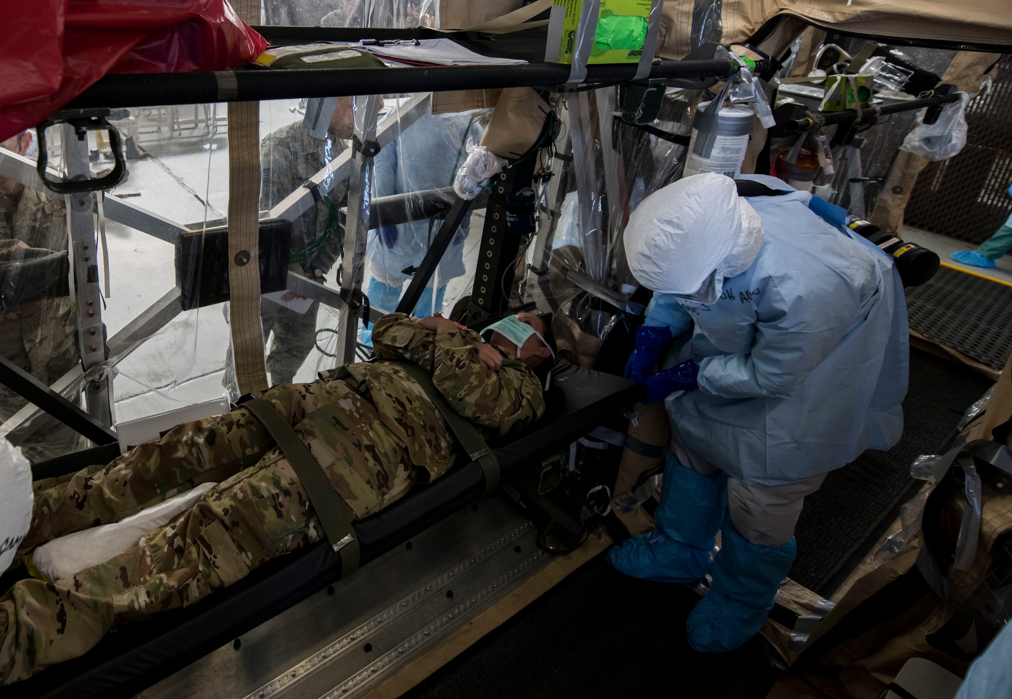 Staff Sgt. Lee Nembhard, an aeromedical evacuation technician assigned to the 375th Aeromedical Evacuation Squadron from Scott Air Force Base, Ill., fastens a litter to a Transport Isolation System during a TIS training exercise at Joint Base Charleston, S.C., October 23, 2019. The TIS is a device used to transport Ebola patients, either by C-17 Globemaster III or C-130 Hercules, while preventing the spread of disease to medical personnel and aircrews until the patient can get to one of three designated hospitals in the United States that can treat Ebola patients. JB Charleston is currently the only military installation with a TIS. The TIS mission is a sub-specialty of the aeromedical evacuation mission which requires frequent training to maintain readiness.