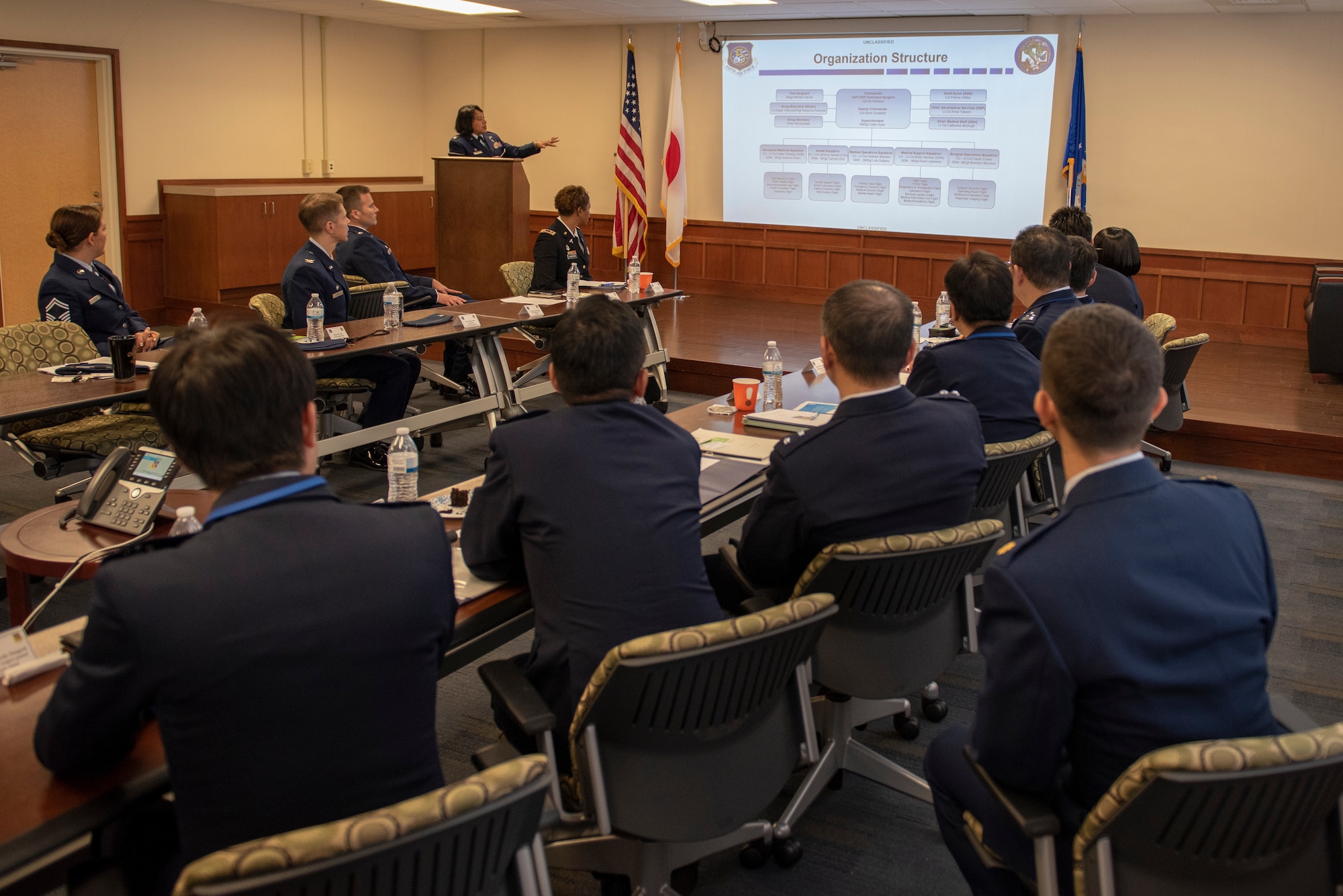 U.S. Air Force Col. Iris Reedom, United States Forces Japan Surgeon General and 374th Medical Group commander, provides a brief rundown of the organizational structure to Japanese Air Self-Defense Force Maj. Gen. Shinya Bekku, JASDF Surgeon General, and his staff at Yokota Air Base, Japan, Oct. 28, 2019.
