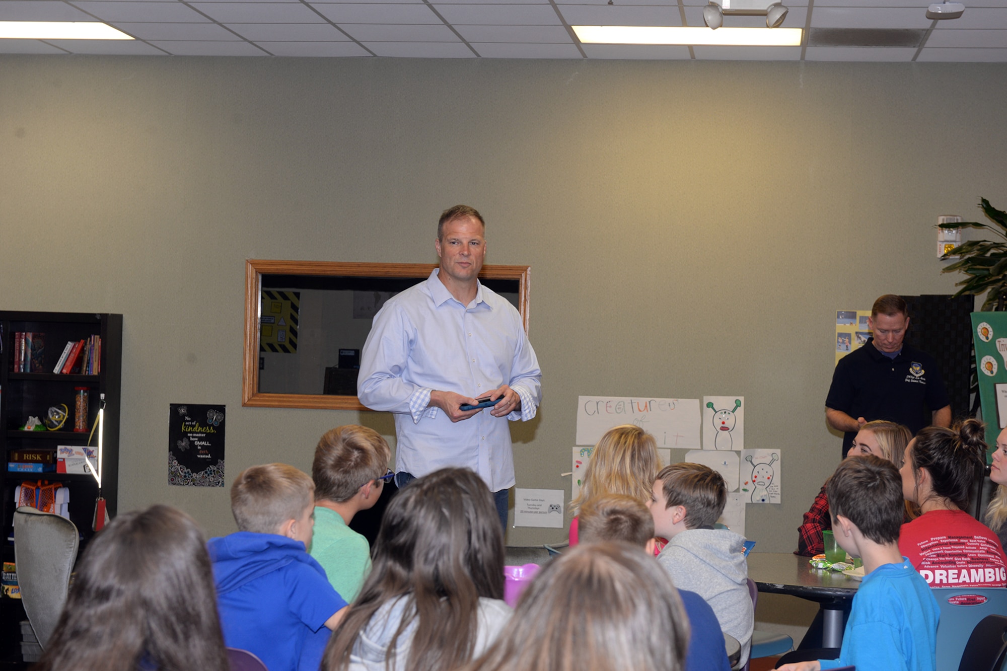 The 595th Command and Control Group commander speaks to crowd of tweens and teens.