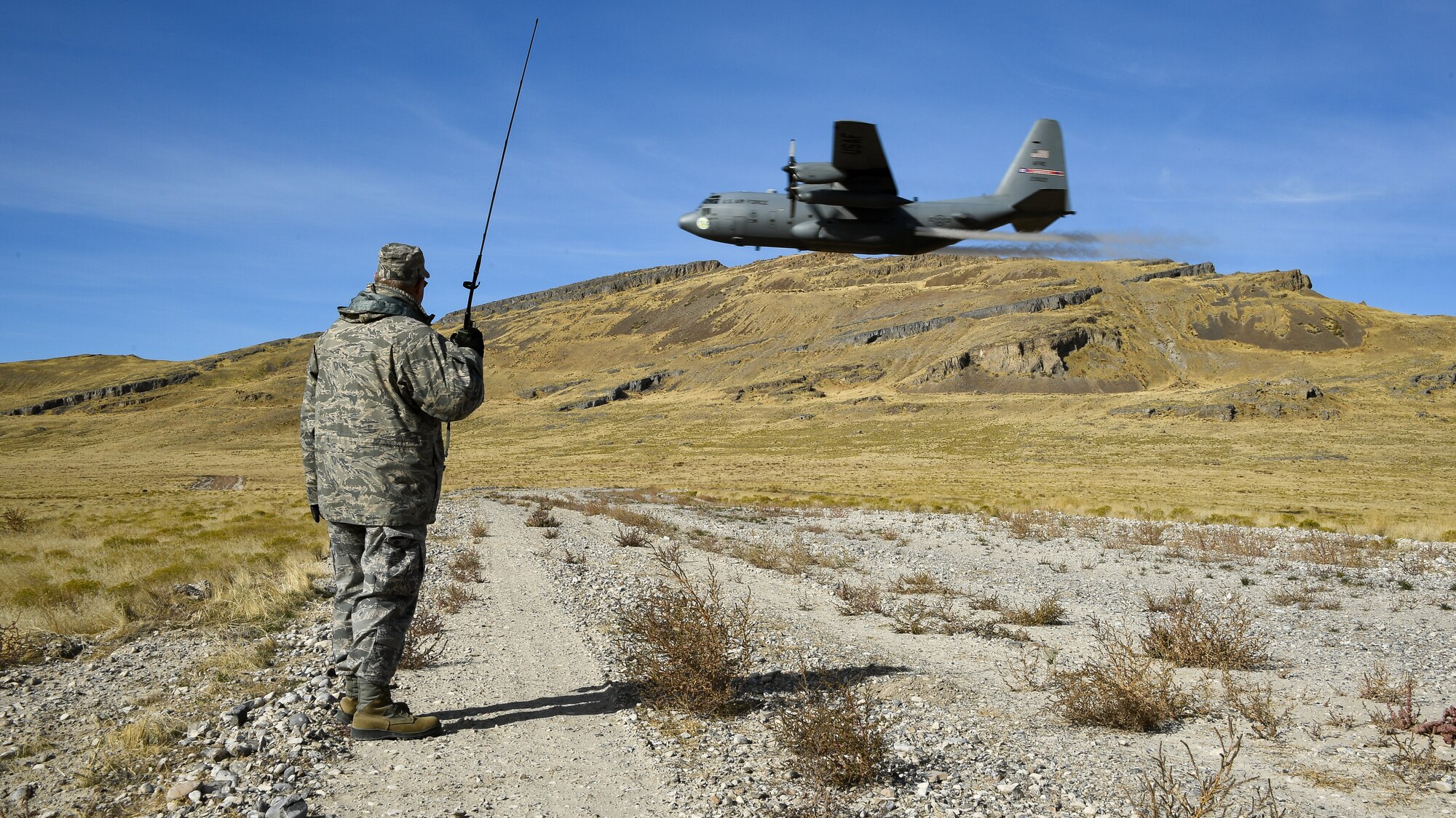 Lt. Col. Don Teig with the Reserve 757th Airlift Squadron communicates with an airbourne C-130 Hercules crew during an aerial spray operation at the Utah Test and Training Range on Oct. 24, 2019.