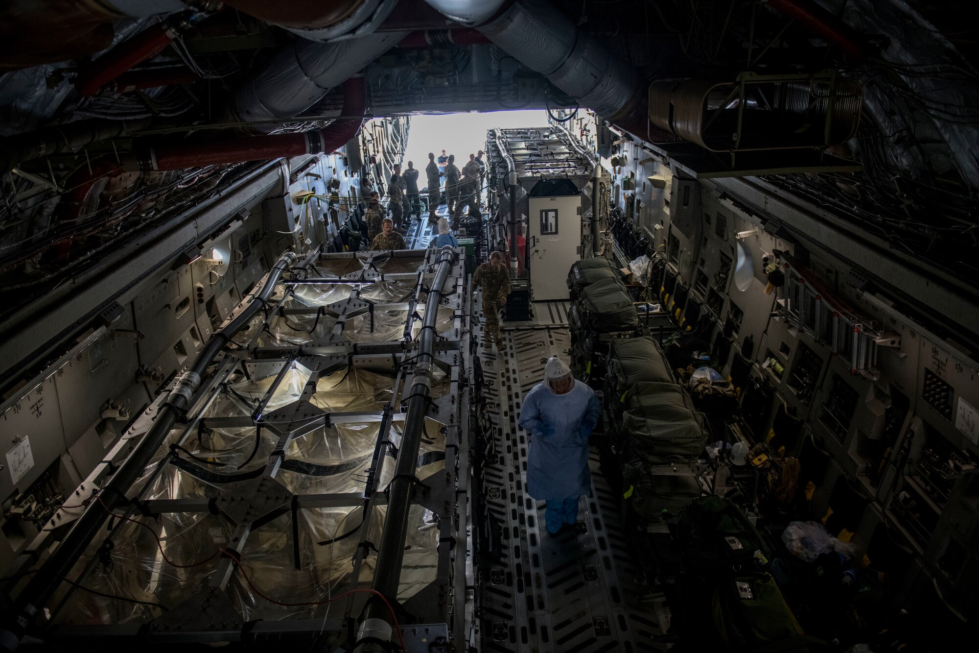 Flight nurses and critical care air transport team members assigned to the 43rd Aeromedical Evacuation Squadron from Pope Army Air Field, N.C., and 375th AES from Scott Air Force Base, Ill., prepare a Transport Isolation System for simulated Ebola patients during a TIS training exercise at Joint Base Charleston, S.C., October 23, 2019. The TIS is a device used to transport Ebola patients, either by C-17 Globemaster III or C-130 Hercules, while preventing the spread of disease to medical personnel and aircrews until the patient can get to one of three designated hospitals in the United States that can treat Ebola patients. JB Charleston is currently the only military installation with a TIS. The TIS mission is a sub-specialty of the aeromedical evacuation mission which requires frequent training to maintain readiness.