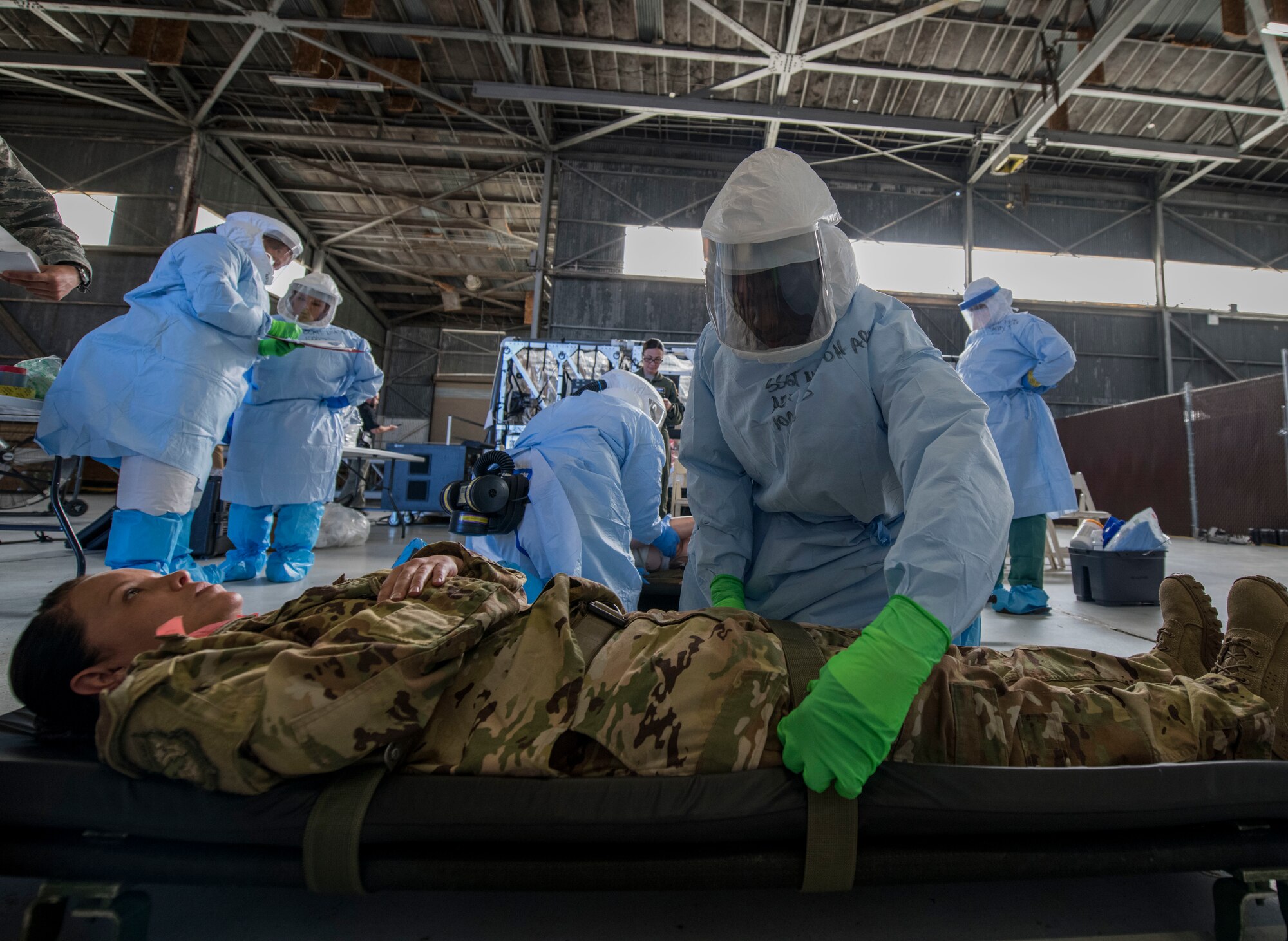 Staff Sgt. Lee Nembhard, an aeromedical evacuation technician assigned to the 375th Aeromedical Evacuation Squadron from Scott Air Force Base, Ill., straps a simulated Ebola patient to a litter during a Transport Isolation System training exercise at Joint Base Charleston, S.C., October 23, 2019. The TIS is a device used to transport Ebola patients, either by C-17 Globemaster III or C-130 Hercules, while preventing the spread of disease to medical personnel and aircrews until the patient can get to one of three designated hospitals in the United States that can treat Ebola patients. JB Charleston is currently the only military installation with a TIS. The TIS mission is a sub-specialty of the aeromedical evacuation mission which requires frequent training to maintain readiness.
