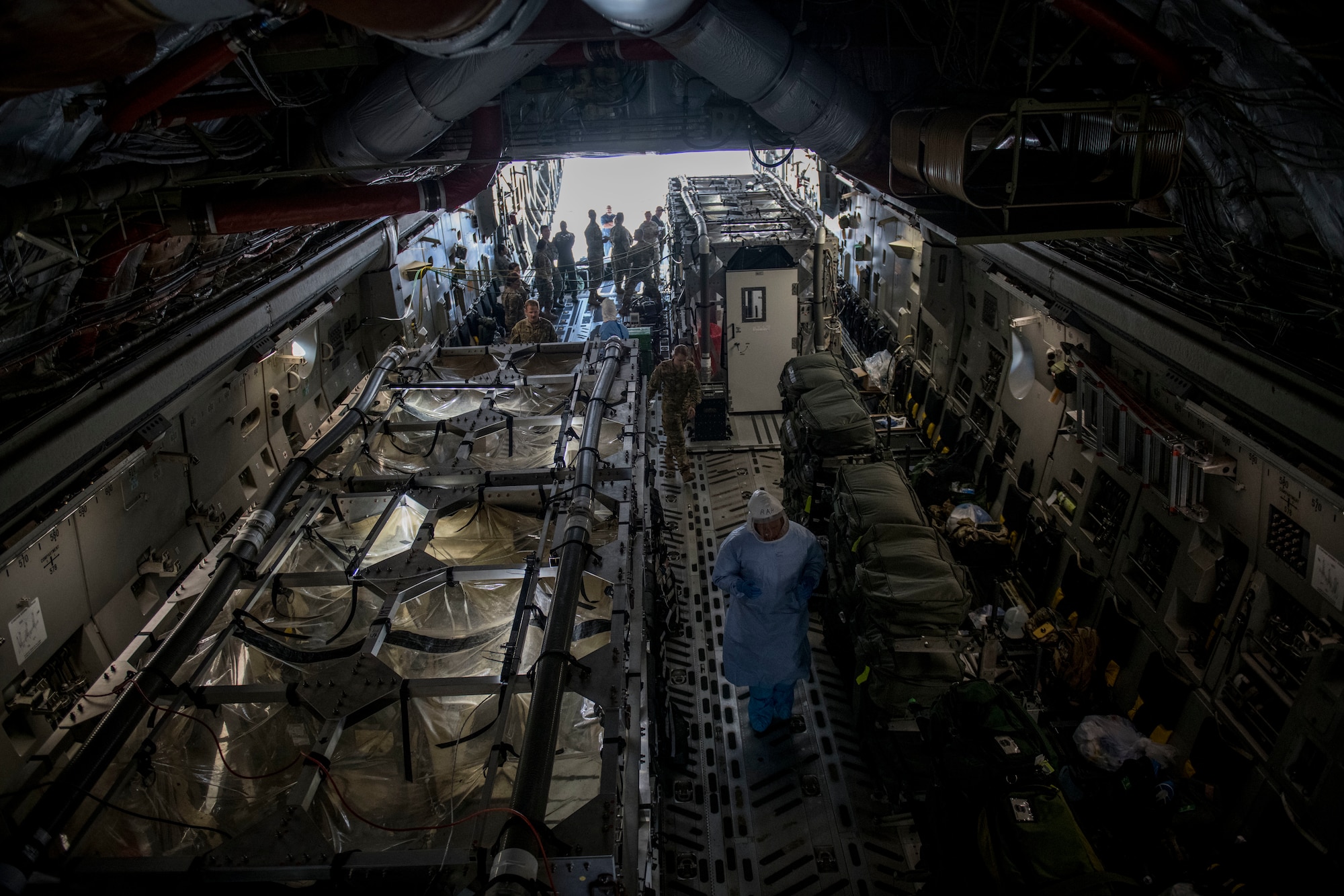 Flight nurses and critical care air transport team members assigned to the 43rd Aeromedical Evacuation Squadron from Pope Army Air Field, N.C., and 375th AES from Scott Air Force Base, Ill., prepare a Transport Isolation System for simulated Ebola patients during a TIS training exercise at Joint Base Charleston, S.C., October 23, 2019. The TIS is a device used to transport Ebola patients, either by C-17 Globemaster III or C-130 Hercules, while preventing the spread of disease to medical personnel and aircrews until the patient can get to one of three designated hospitals in the United States that can treat Ebola patients. JB Charleston is currently the only military installation with a TIS. The TIS mission is a sub-specialty of the aeromedical evacuation mission which requires frequent training to maintain readiness.
