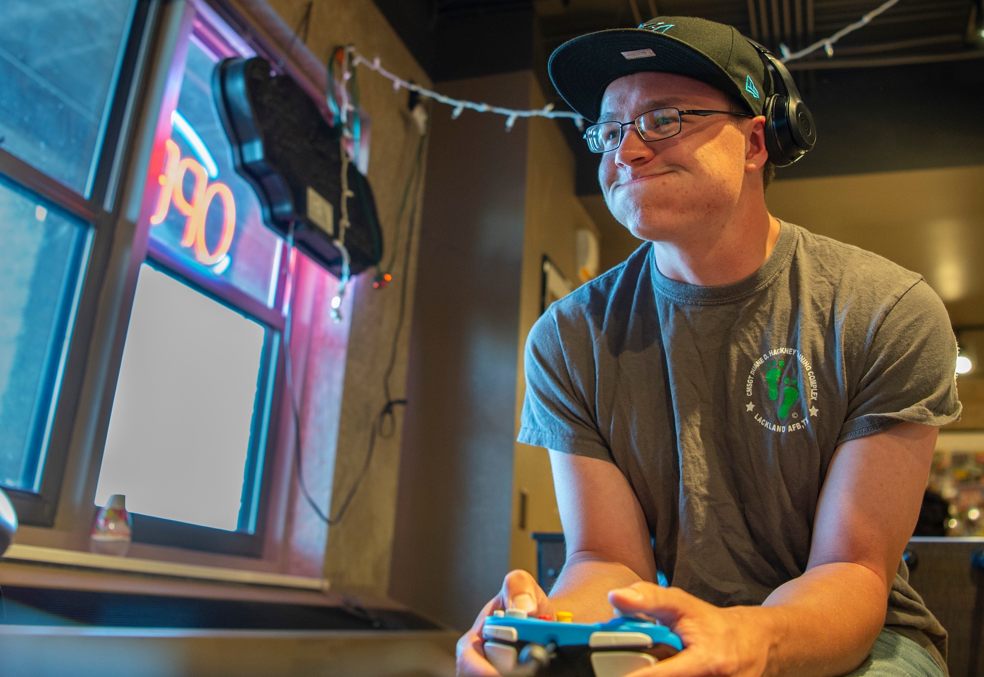 Airman 1st Class Phillippe Breault, 50th Operations Support Squadron student, plays video games during Cyber Wednesday at Discovery Hall on Peterson Air Force Base, Colorado, Sept. 25, 2019. During 21st Space Wing Chaplain hosted event, Airmen are invited to play video games, board games, watch movies, eat pizza and candy. (U.S. Air Force photo by Airman 1st Class Jonathan Whitely)