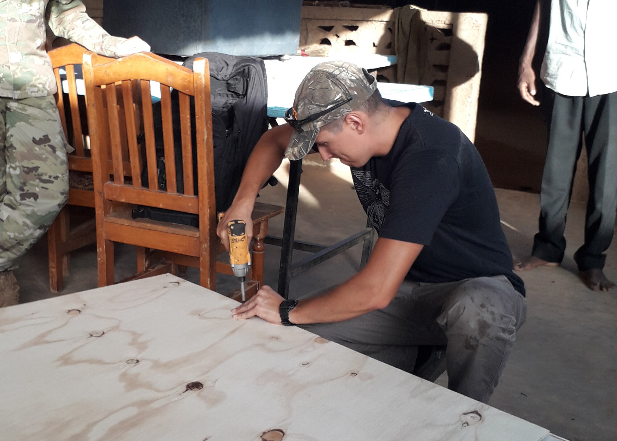 A volunteer constructs a shelving unit at the Sara-Niger Rehabilitation Center Movement for Women and Girls in Niamey, Niger. From Sept. 21 to Oct. 14, 2019, Airmen deployed to Nigerien Air Base 101 and U.S. Embassy personnel renovated the local women’s vocational school that teaches local women techniques for making clothing, providing them with a profession and a source of income. (Courtesy Photo)