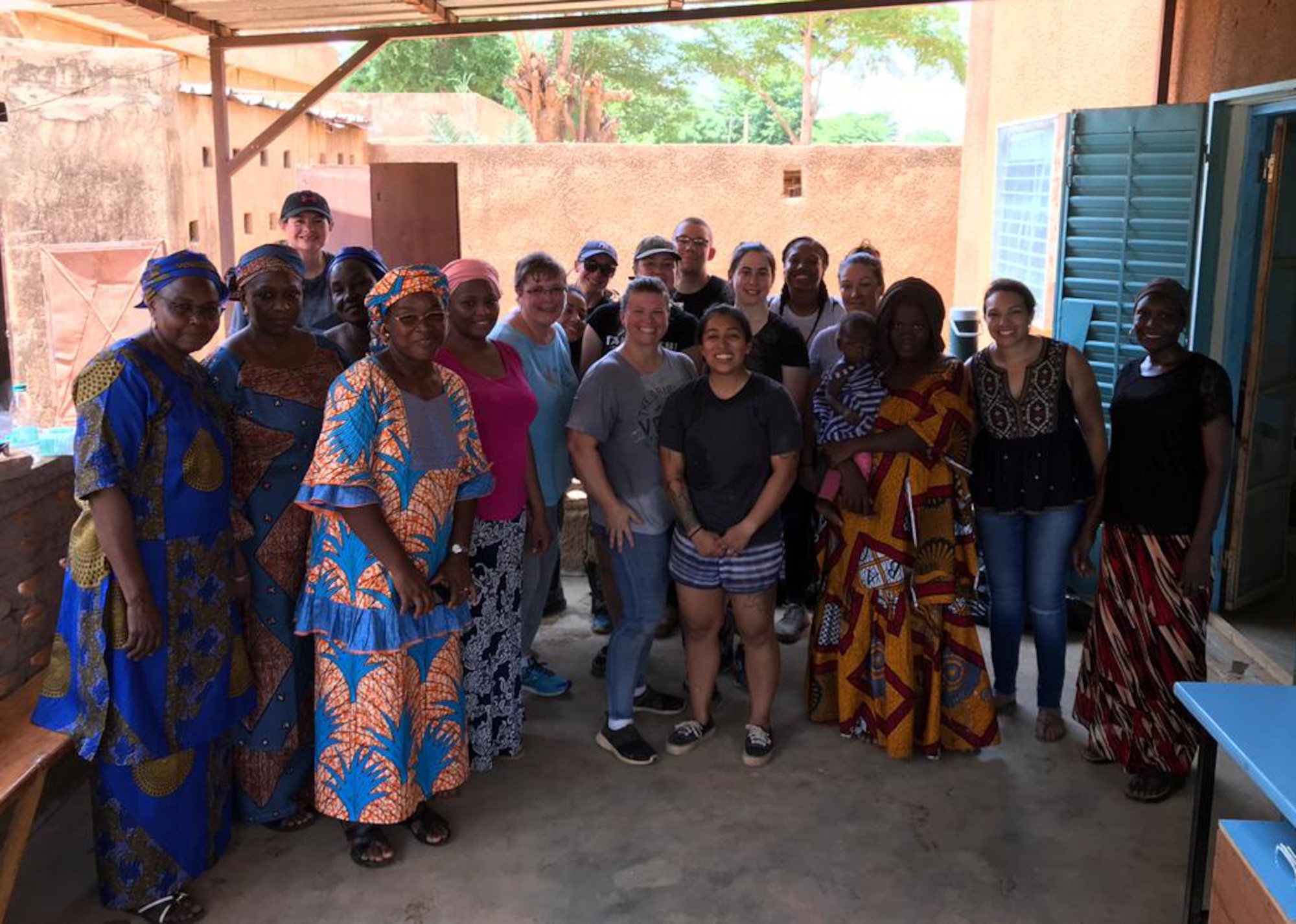 Volunteers pose with staff of the Sara-Niger Rehabilitation Center Movement for Women and Girls during renovation operations in Niamey, Niger. From Sept. 21 to Oct. 14, 2019, Airmen deployed to Nigerien Air Base 101 and U.S. Embassy personnel renovated the local women’s vocational school that teaches local women techniques for making clothing, providing them with a profession and a source of income. (Courtesy Photo)