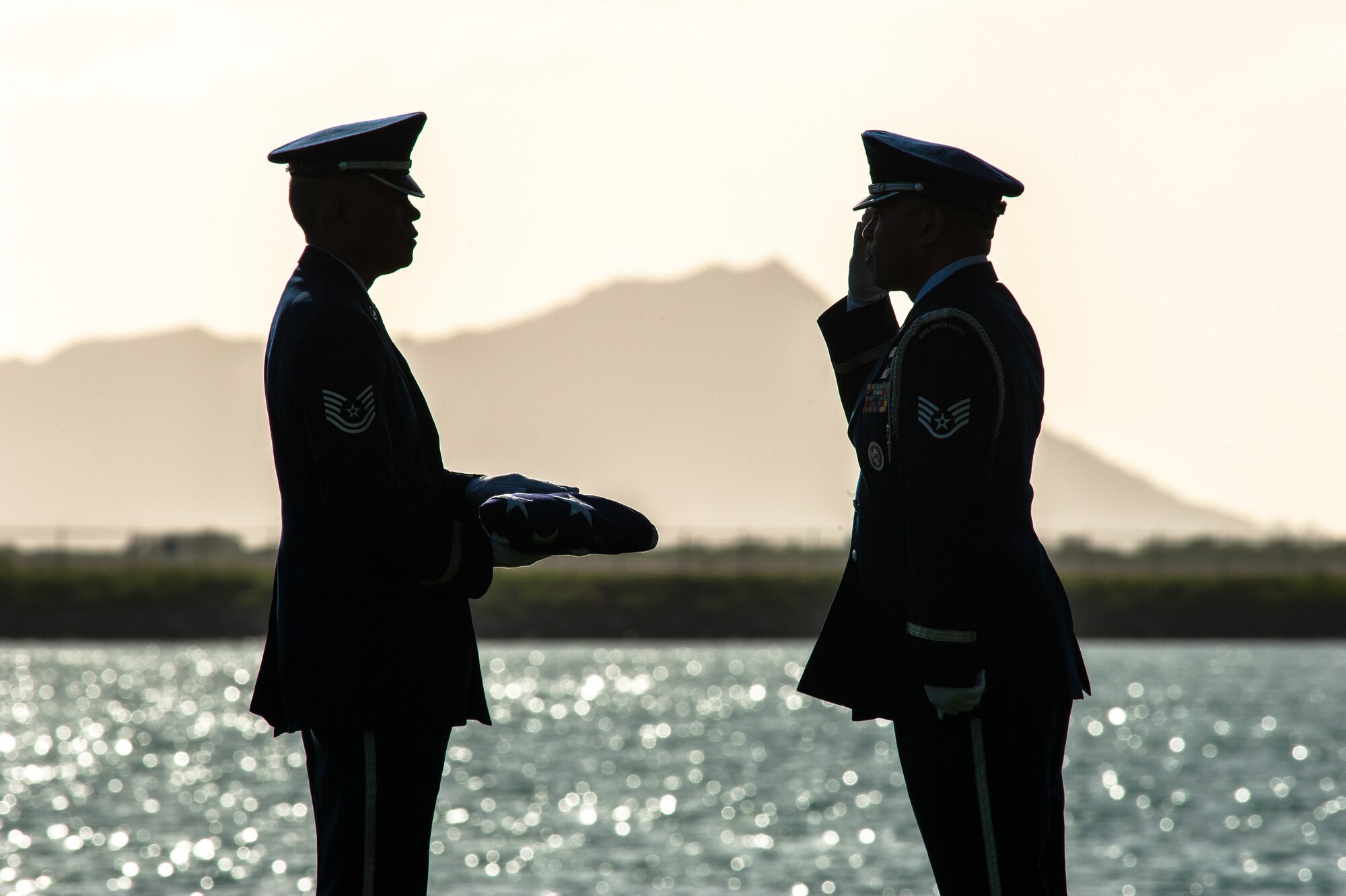 Tech. Sgt. Mark Crabbe and Staff Sgt. Darrell Bactad, 204th Airlift Squadron information managers, practice Honor Guard ceremonial movements Oct. 4, 2019, at Joint Base Pearl Harbor-Hickam, Hawaii. The two friends have performed military ceremonies side-by-side in the Hawaii Air National Guard Honor Guard team since the early 2000s. Crabbe became an honor guardsmen in 2001 and Bactad joined in 1999, when the unit was established. (U.S. Air National Guard photo by Senior Airman John Linzmeier)