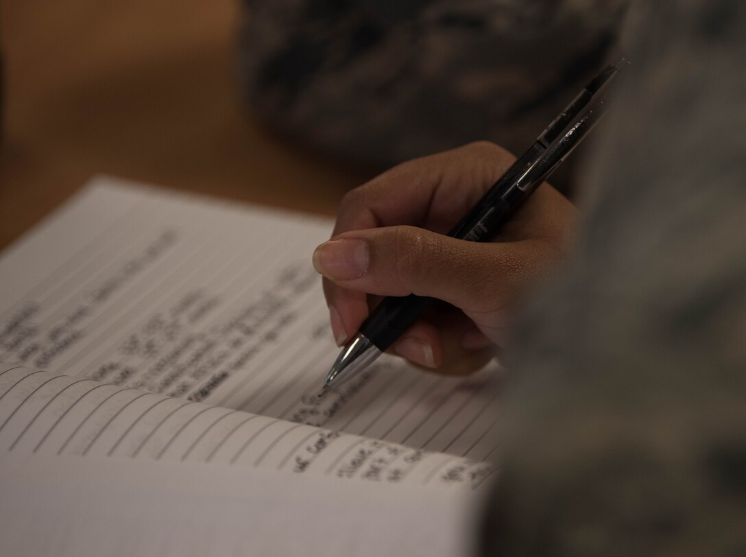 A U.S. Air Force Airman takes notes during an Airman professional enhancement seminar at Joint Base Langley-Eustis, Virginia, Aug. 20, 2019.