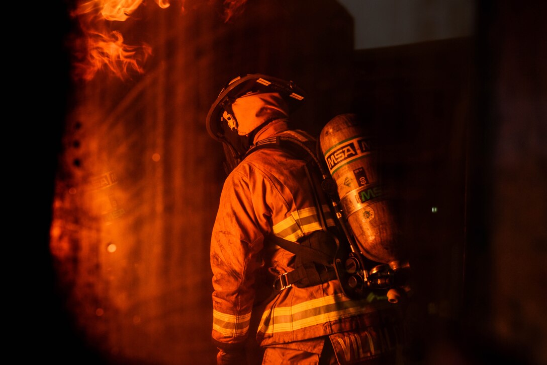 An airman battles a fire.