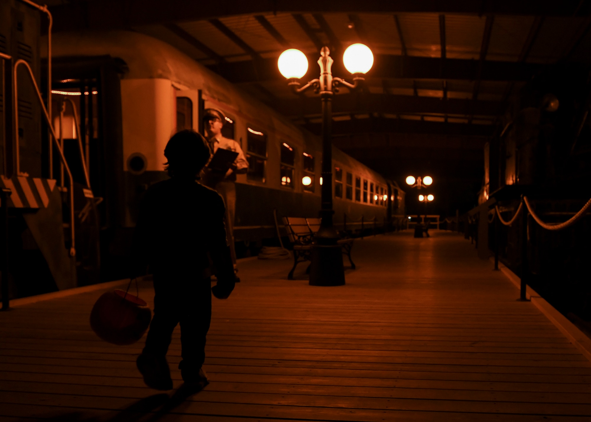 A child dressed in a Halloween costume walks through the train exhibit at the 10th annual Night at the Transportation Museum celebration at Joint Base Langley-Eustis, Virginia, Oct. 28, 2019.