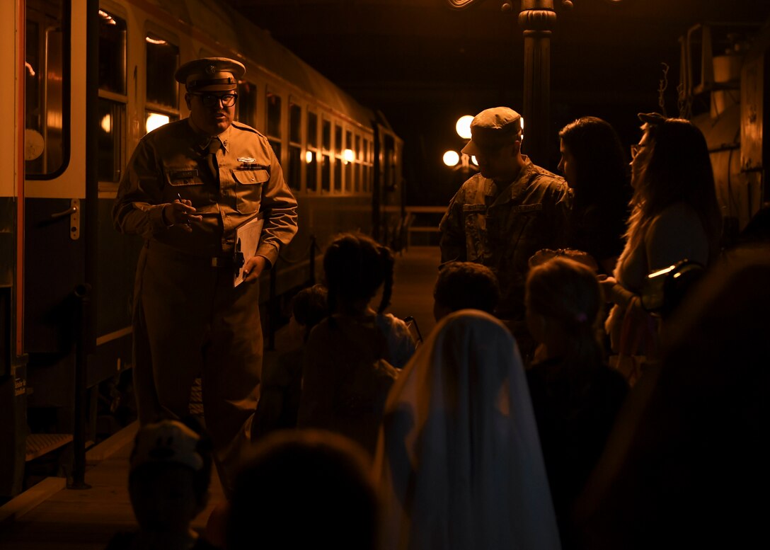 A U.S. Army Transportation volunteer speaks to community members during the 10th annual Night at the Transportation Museum Halloween celebration at Joint Base Langley-Eustis, Virginia, Oct. 28, 2019.