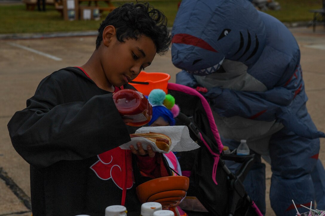 An attendee puts ketchup on a hot dog at the Fort Eustis Fall Fest at Joint Base Langley-Eustis, Va., Oct. 25, 2019.