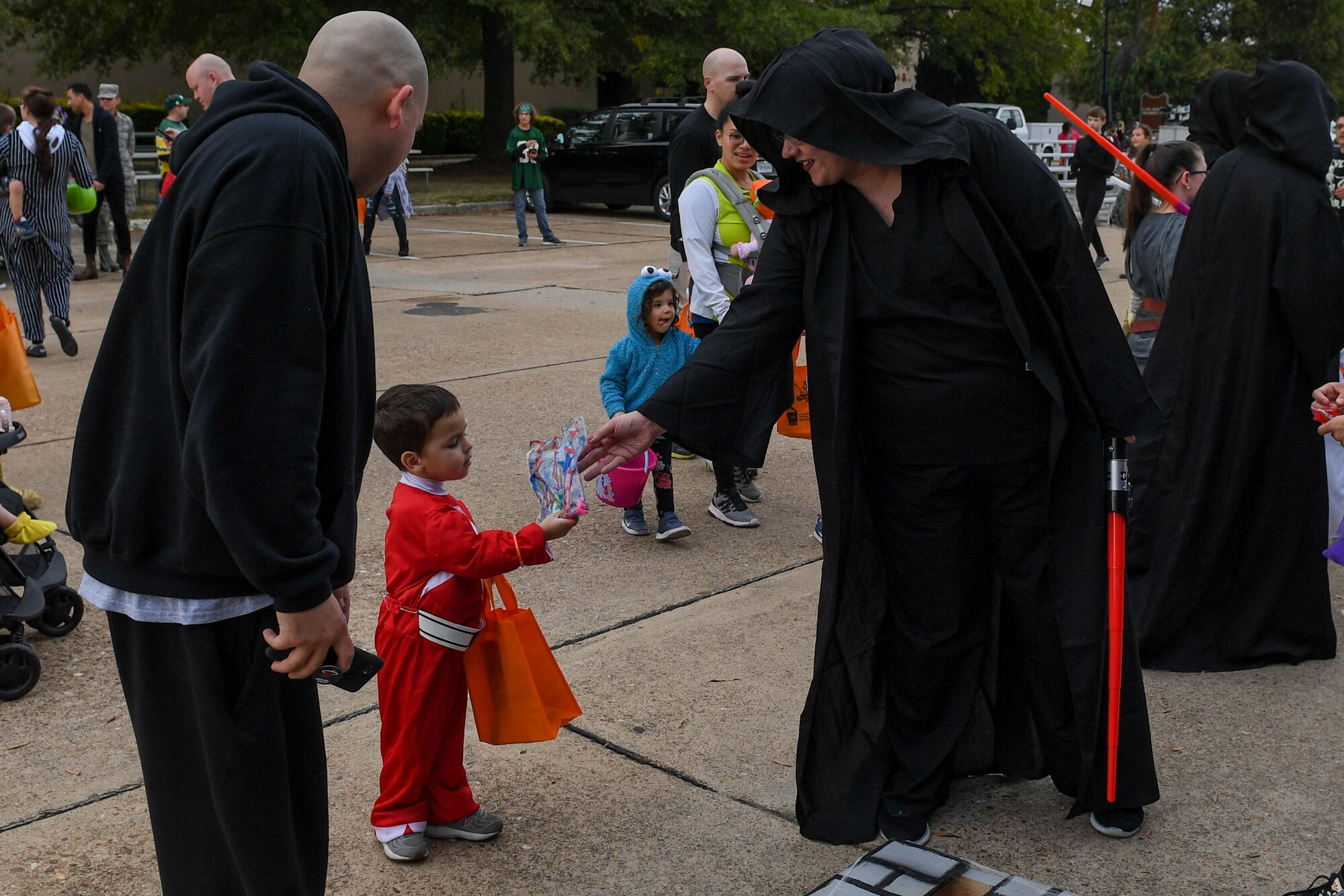 A participant at the Fort Eustis Fall Fest hands gifts to a child at Joint Base Langley-Eustis, Virginia, Oct. 25, 2019.