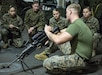 U.S. Marines with the Female Engagement Team (FET), 26th Marine Expeditionary Unit (MEU), participate in an M249 light machine gun class during Composite Training Unit Exercise (COMPTUEX) aboard the amphibious assault ship USS Bataan (LHD 5) in the Atlantic Ocean Oct. 11, 2019.