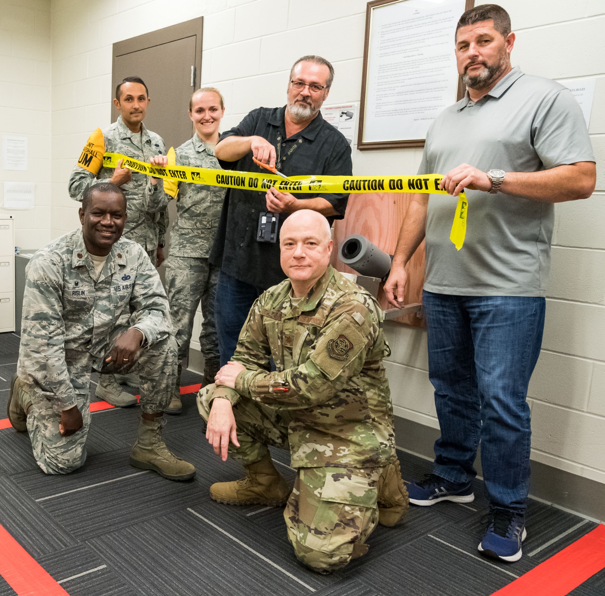 Tech. Sgt. Damien Seelbach, 436th Communications Squadron cybersecurity noncommissioned officer in charge and Unit Marshal; 1st Lt. Rachael Burks, 436 CS cyber operations flight commander and Unit Marshal; Dr. Craig Gilbert, 436 CS chief of knowledge management and Unit Marshal Program Manager; Richard Barker, 436th Security Forces Squadron; Majs. Schneider Rislin, 436 SFS commander and Peter Dell’Accio, 436 CS commander, pose for a photo prior to a ribbon-cutting ceremony in the 436 CS’s arming area, Oct. 24, 2019, on Dover Air Force Base, Del. The 436 CS is the first squadron in the Air Force to create its own arming area in support of the Unit Marshal Program. (U.S. Air Force photo by Roland Balik)