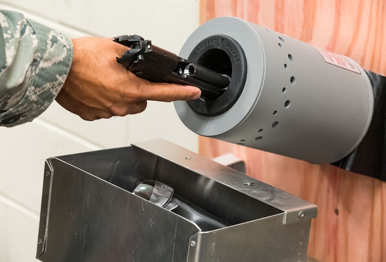 Tech. Sgt. Damien Seelbach, 436th Communications Squadron cybersecurity noncommissioned officer in charge and Unit Marshal, places a Beretta M9 in the clearing barrel during the disarming process conducted in the 436 CS’s arming area, Oct. 24, 2019, on Dover Air Force Base, Del. The UM Program is designed as an active shooter deterrent program. (U.S. Air Force photo by Roland Balik)