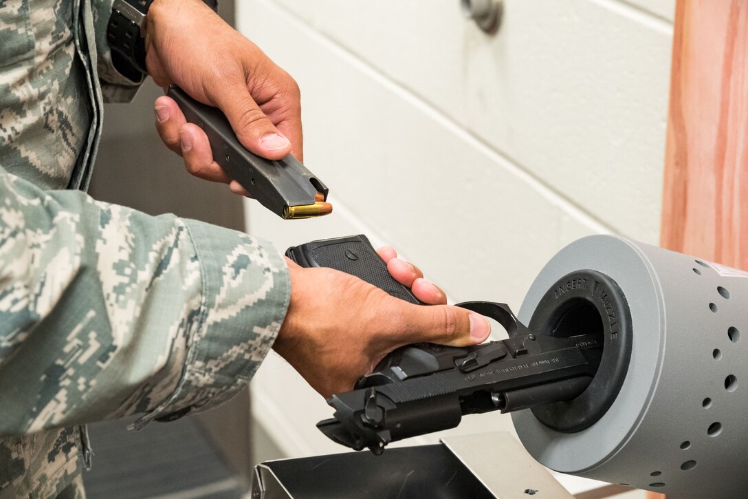 Tech. Sgt. Damien Seelbach, 436th Communications Squadron cybersecurity noncommissioned officer in charge and Unit Marshal, removes the clip containing 9mm bullets from a Beretta M9 during the disarming process conducted in the 436 CS’s arming area, Oct. 24, 2019, on Dover Air Force Base, Del. Currently, the squadron has two trained UMs. (U.S. Air Force photo by Roland Balik)