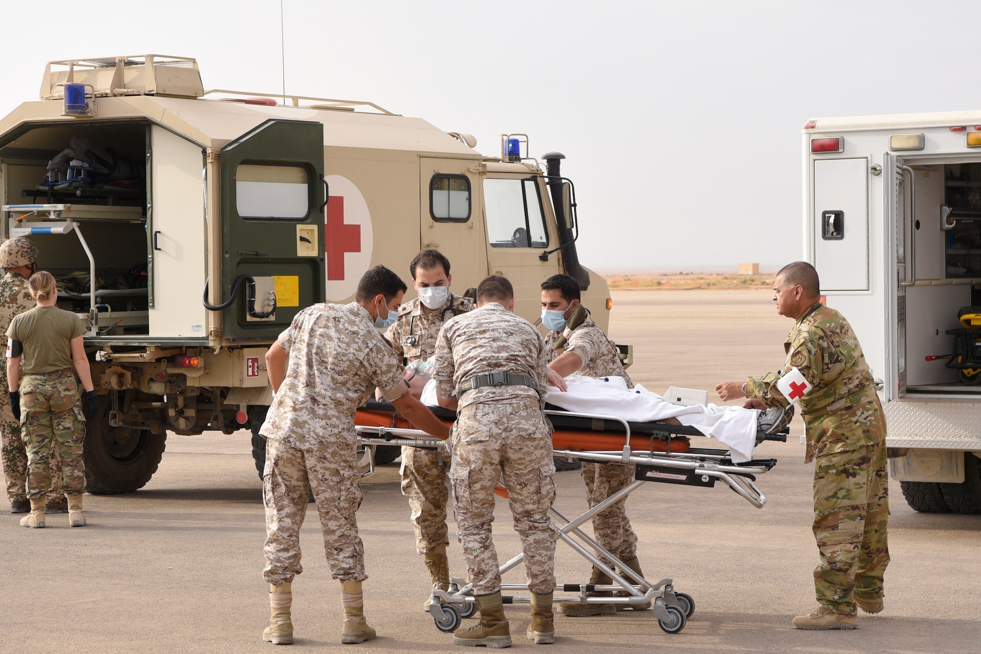 U.S. Air Force and Royal Jordanian Air Force medical teams transport a patient with simulated injuries during a Mass Casualty exercise at the 332d Air Expeditionary Wing, Oct. 16, 2019. The teams trained together to share techniques and break language barriers to operate as a unified multi-lateral team. (U.S. Air Force photo by Tech. Sgt. Andrew Satran)