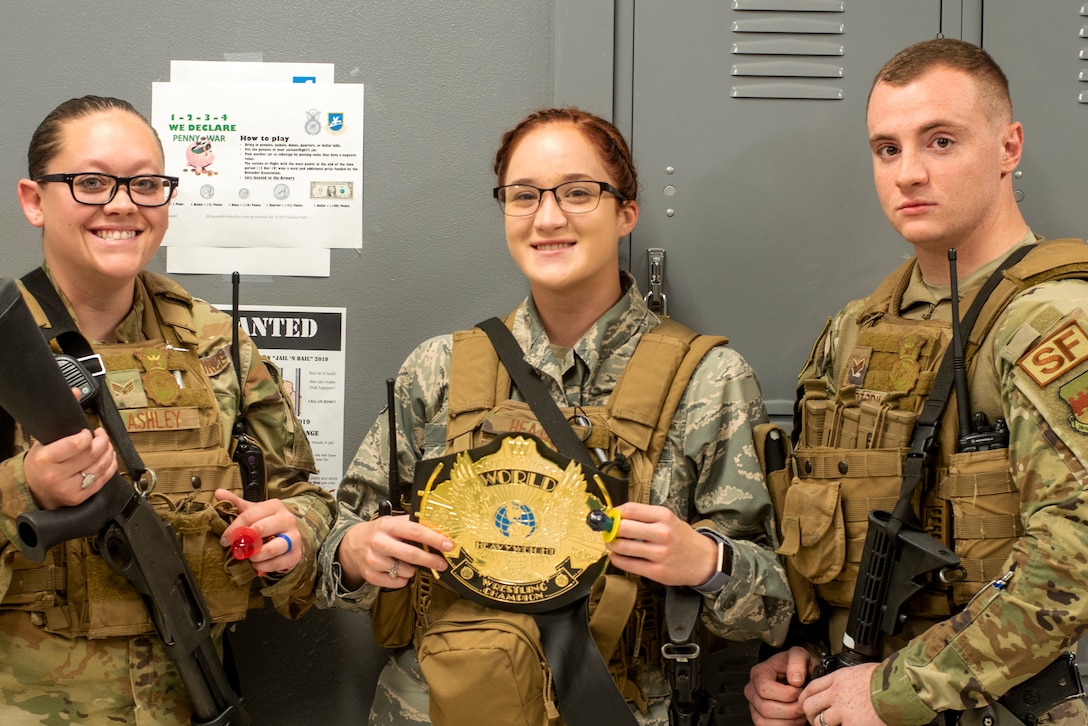U.S. Air Force Senior Airman Meghan Lashley, left, Airman 1st Class Ireland Heath, 20th Security Forces Squadron (SFS) installation entry controllers and Senior Airman Vincent Cortorillo, a 20th SFS patrolman, smile with awards at Shaw Air Force Base, South Carolina, Oct. 25, 2019.