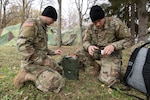 Army Spc. Josh Southerland (left) and Spc. Dillon Devore, both signal systems support specialists from Seymour, Ind., assigned to the 1st Squadron, 152nd Cavalry Regiment, 76th Infantry Brigade Combat Team, 38th Infantry Division, Indiana Army National Guard, set up an AN/PRC-150 multiband radio in a field at Lešť military training center in Slovakia, Oct. 29, 2019.