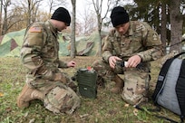 Army Spc. Josh Southerland (left) and Spc. Dillon Devore, both signal systems support specialists from Seymour, Ind., assigned to the 1st Squadron, 152nd Cavalry Regiment, 76th Infantry Brigade Combat Team, 38th Infantry Division, Indiana Army National Guard, set up an AN/PRC-150 multiband radio in a field at Lešť military training center in Slovakia, Oct. 29, 2019.